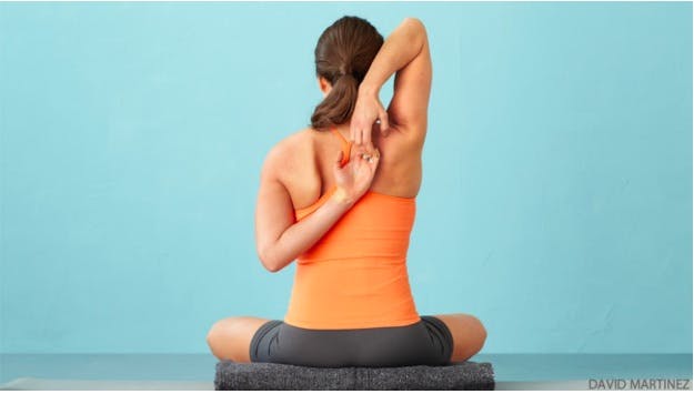 Hand clasped behind back yoga pose
