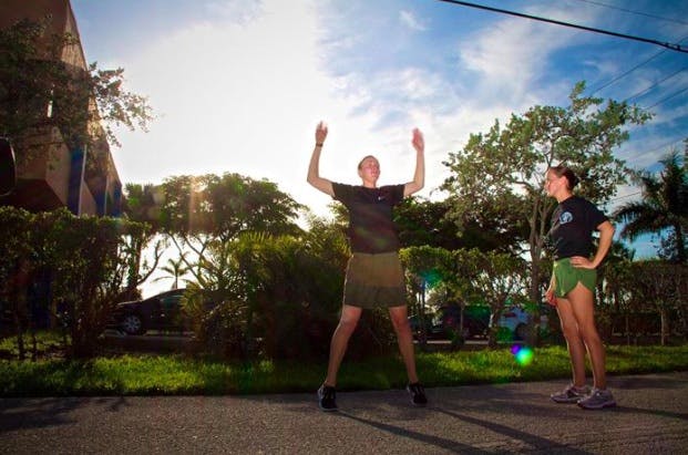 Marine getting better at running by doing jumping jacks