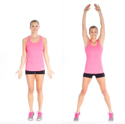 Woman doing jumping jacks as pre-stretch workout before running
