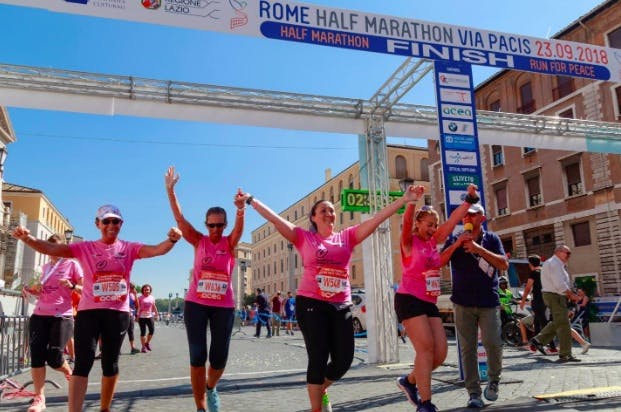 Marathon runners cheering up at the finish line