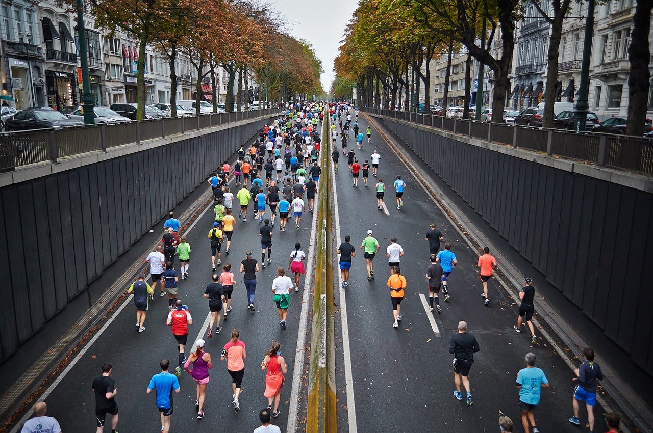 People running a marathon in the street