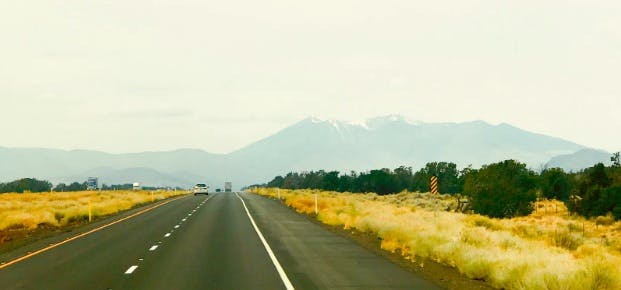 A road in Arizona, with mountains at the horizon.