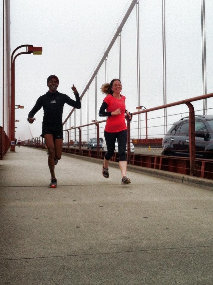 people running on a bridge