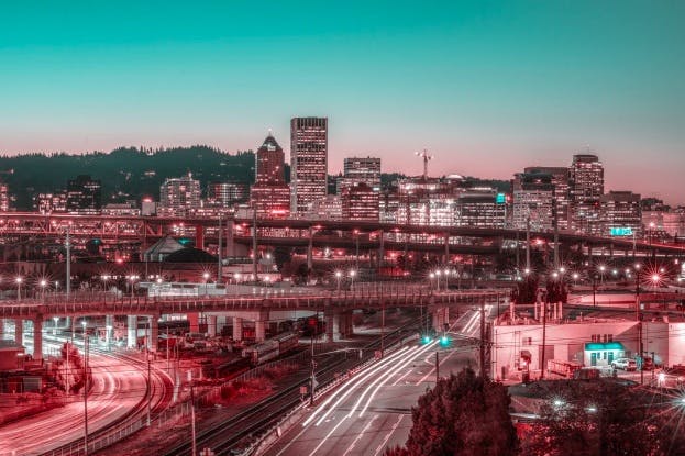 Portland, Oregon, at dusk, the city lights, winding roads and bridges.