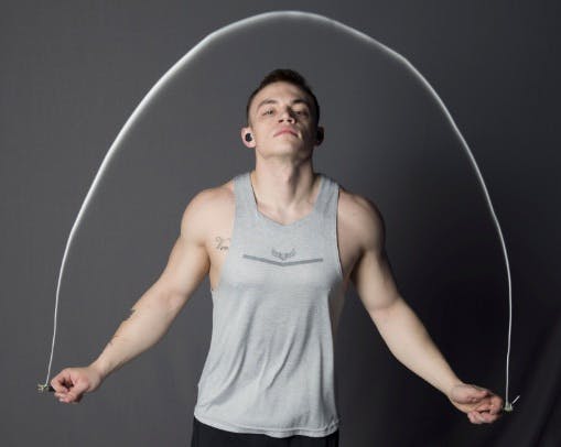 Fit man jumping rope to train his body for running