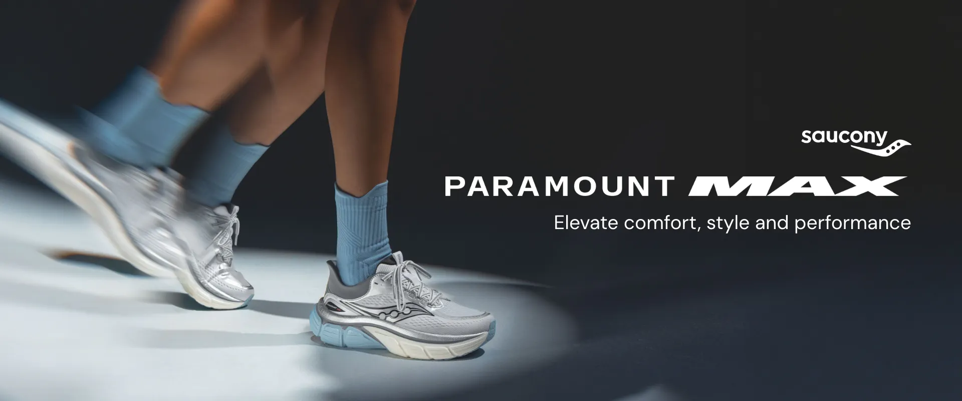 Runner in motion wearing cushioned white Saucony Paramount Max sneakers. Desktop banner emphasizing running shoe comfort, style, and performance.