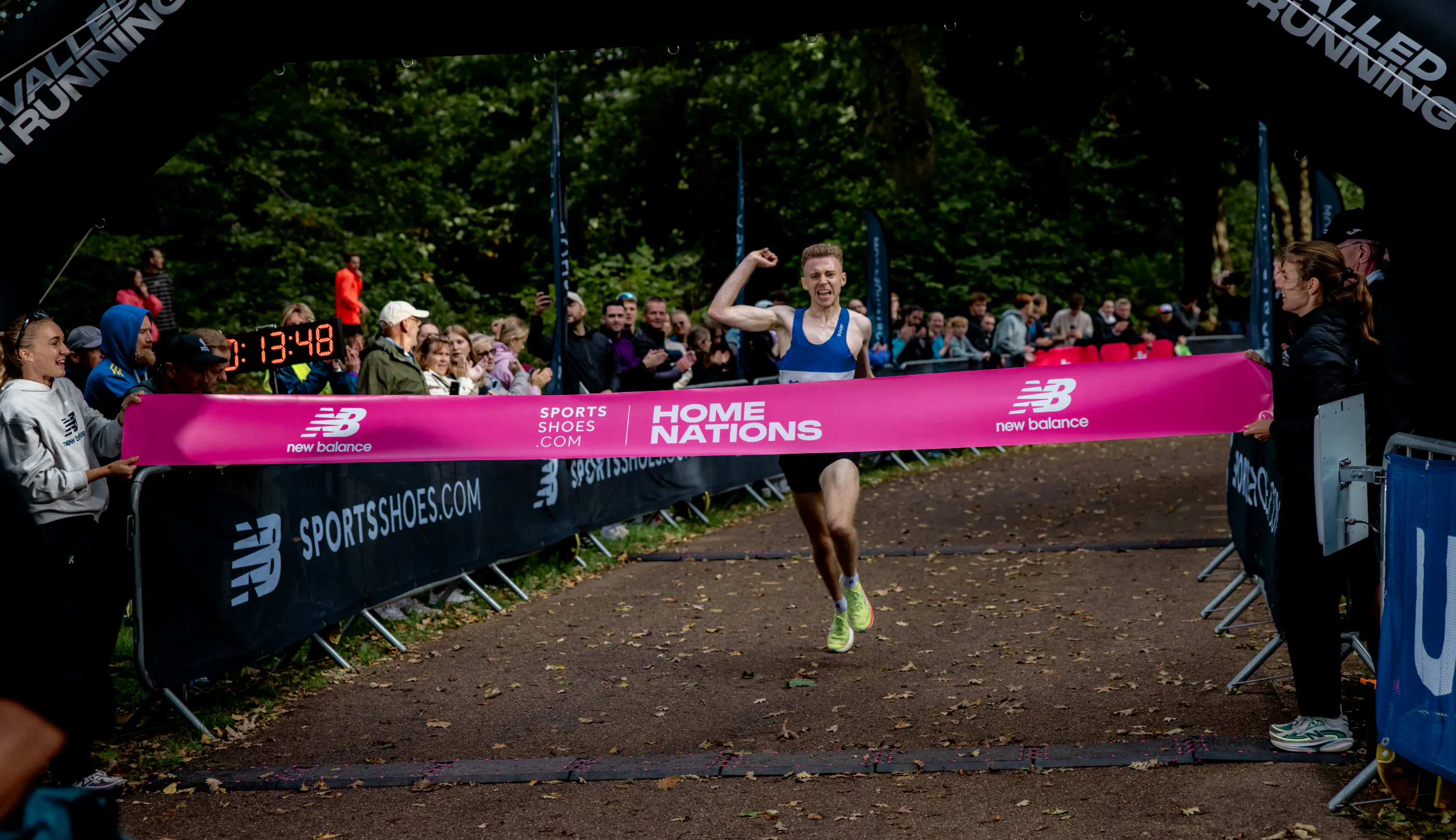 Sportsshoes-podium-home-nations-men's-winner-crossing-the-line