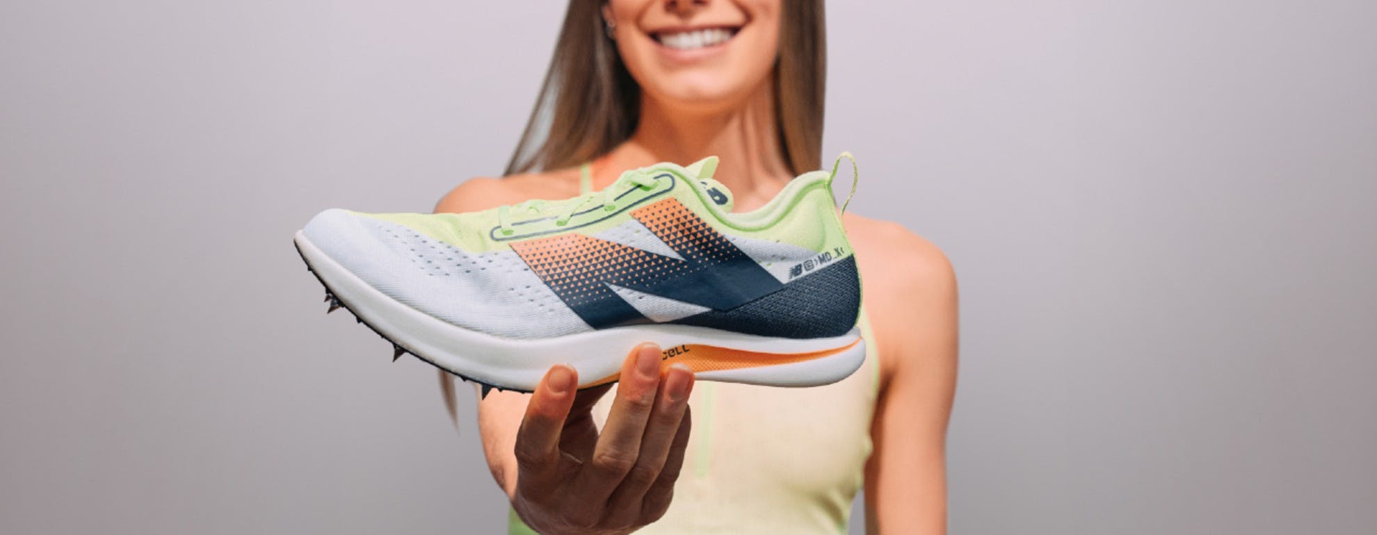 Jess holding New Balance spike