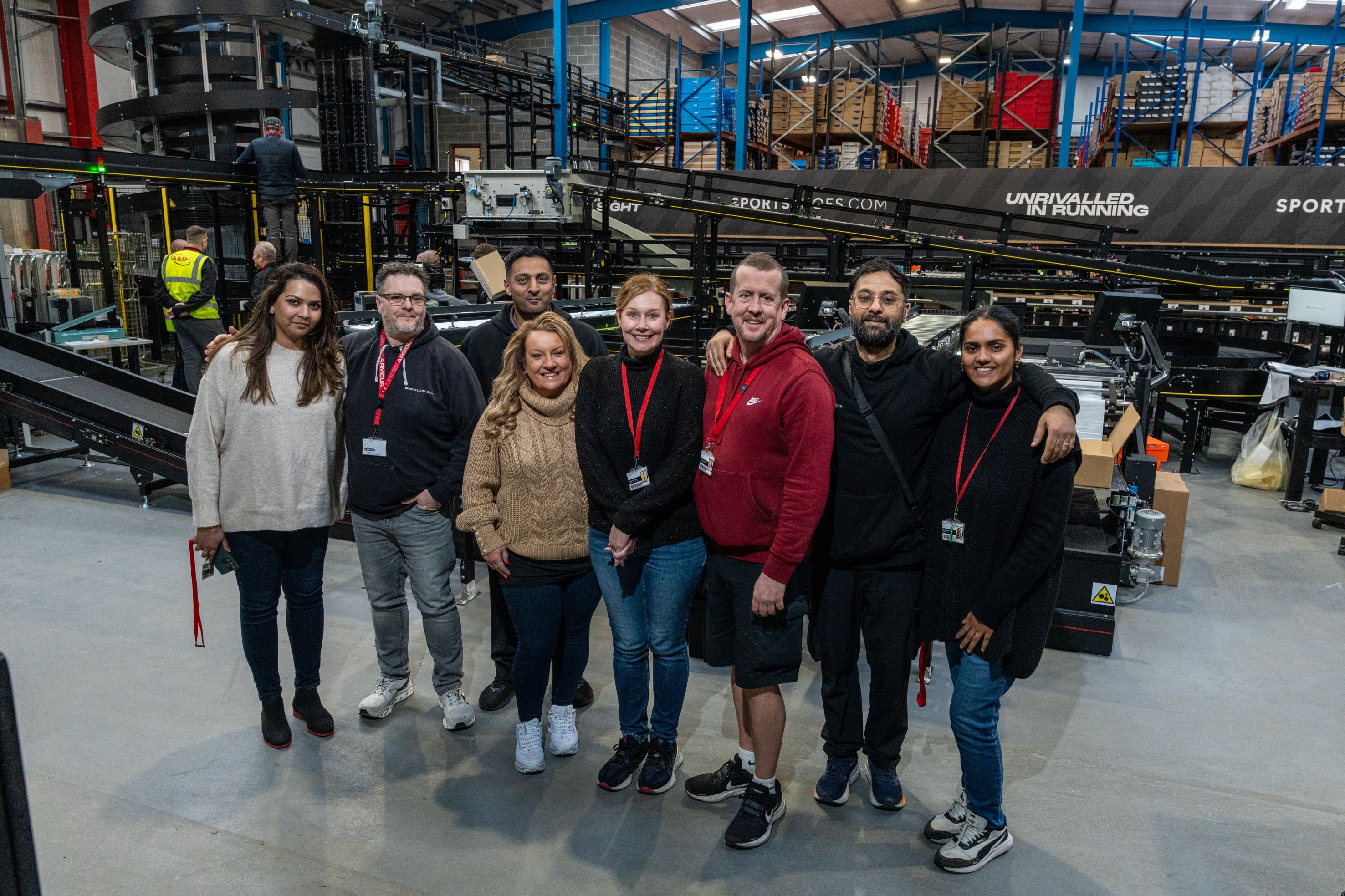 Up and running - SportsShoes.com general manager, Louise Cartner (fourth from left), and her team in front of the semi-automated warehouse system