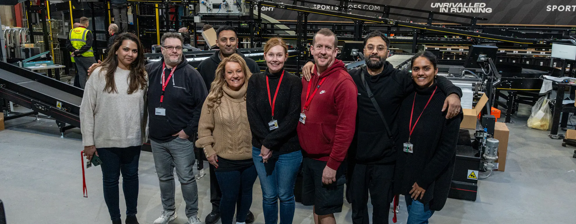Up and running - SportsShoes.com general manager, Louise Cartner (fourth from left), and her team in front of the semi-automated warehouse system