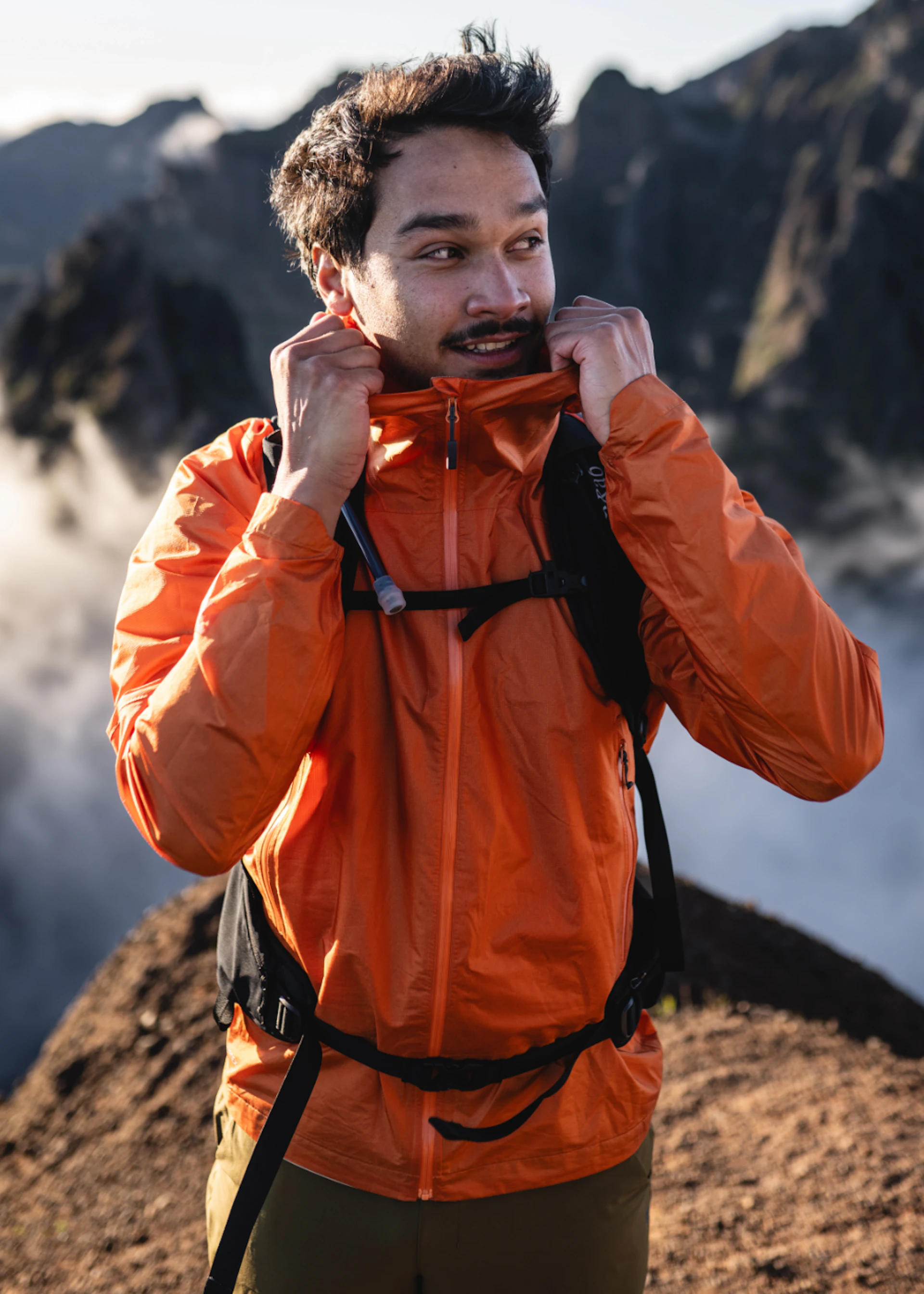 Man in orange jacket on the mountains