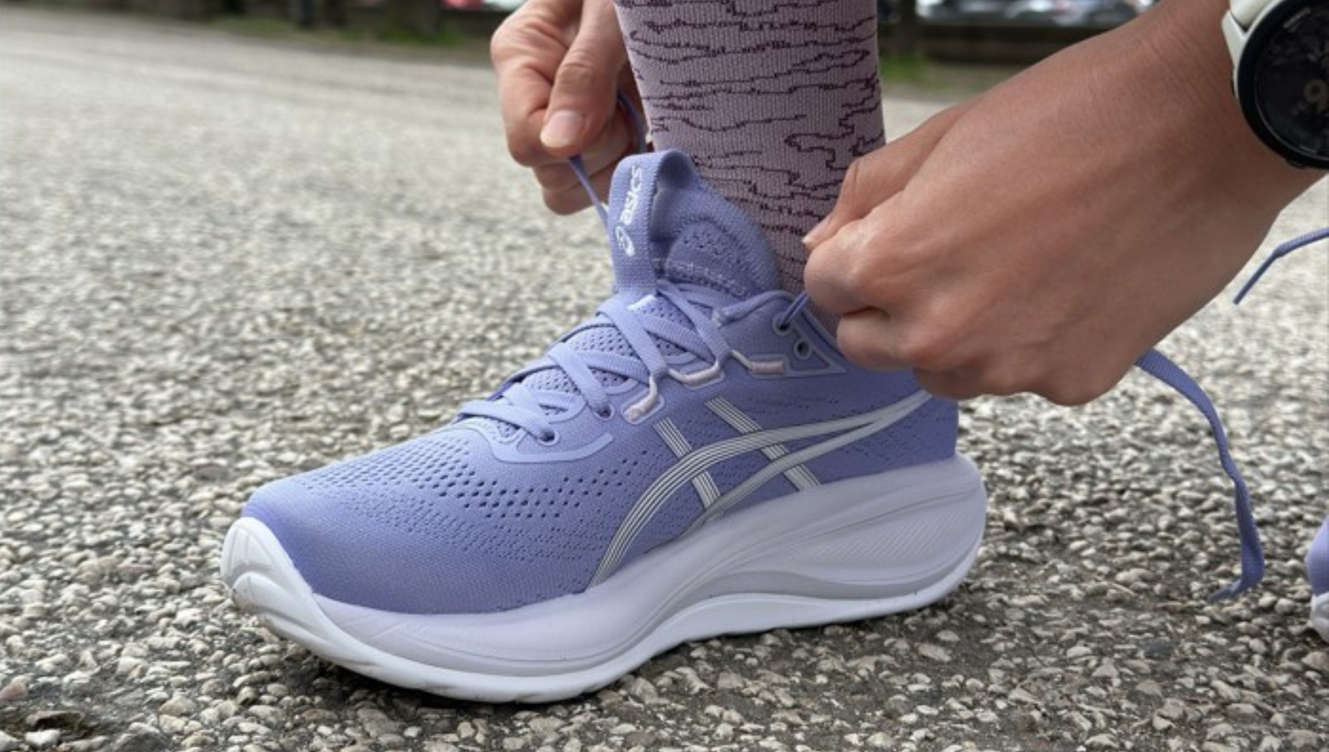 Lacing up ASICS Gel-Cumulus running shoes 