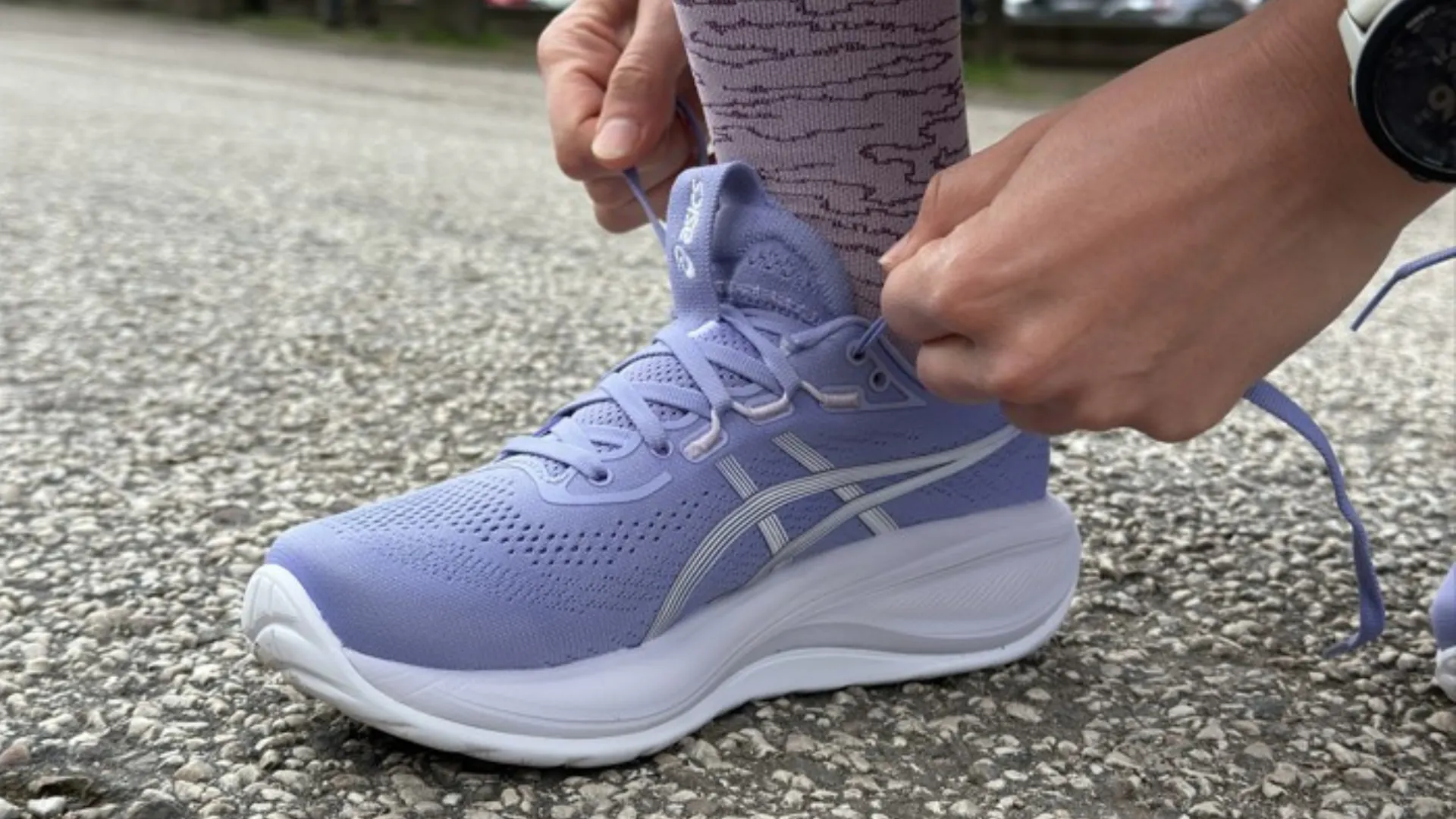 Lacing up ASICS Gel-Cumulus running shoes