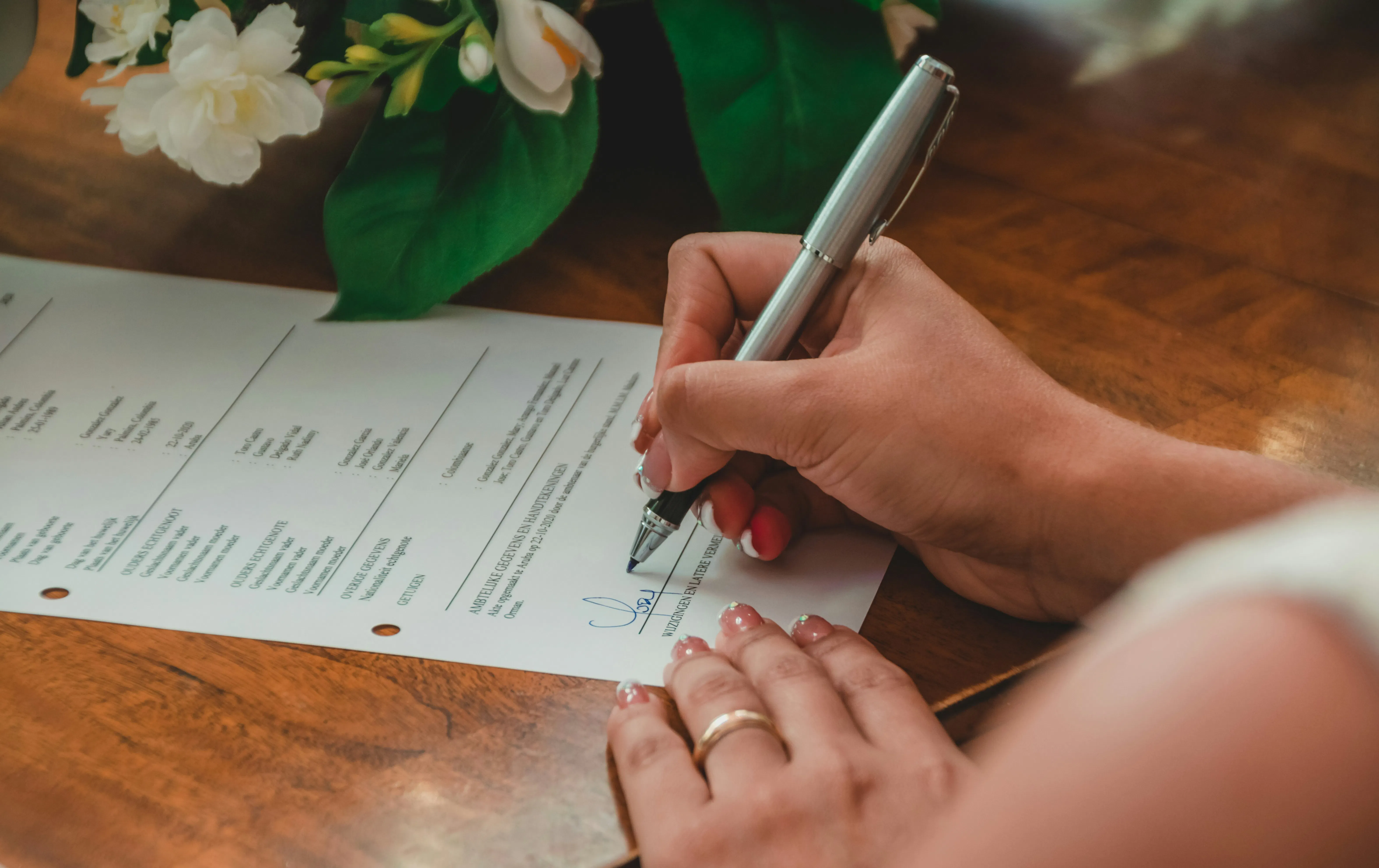 Buyer signing a property purchase agreement, illustrating the arras contract and deposit stage when buying a home in Spain.