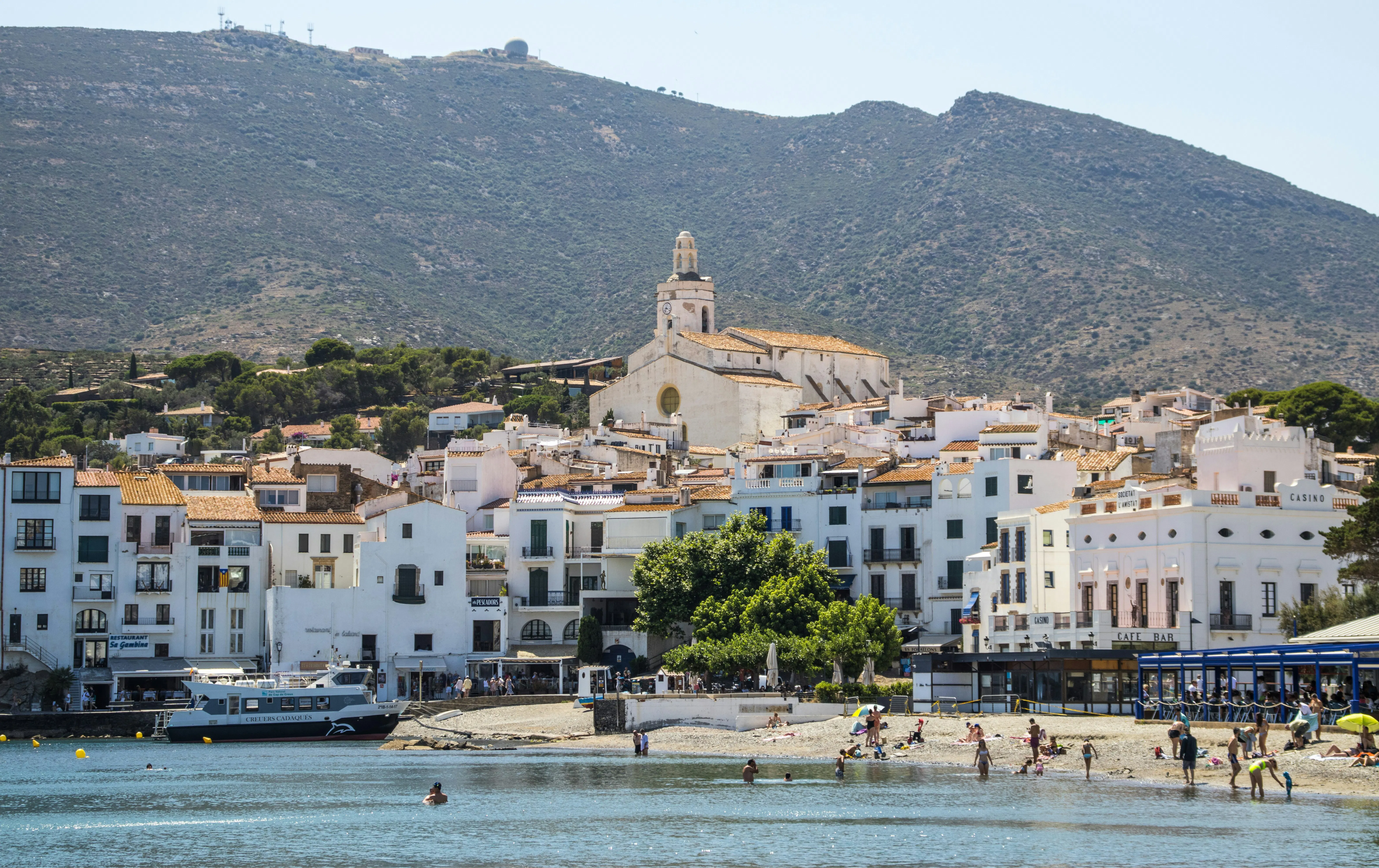 Coastal town in Catalonia with residential buildings and a waterfront, illustrating the variety of local property markets affected by changing rental regulations.