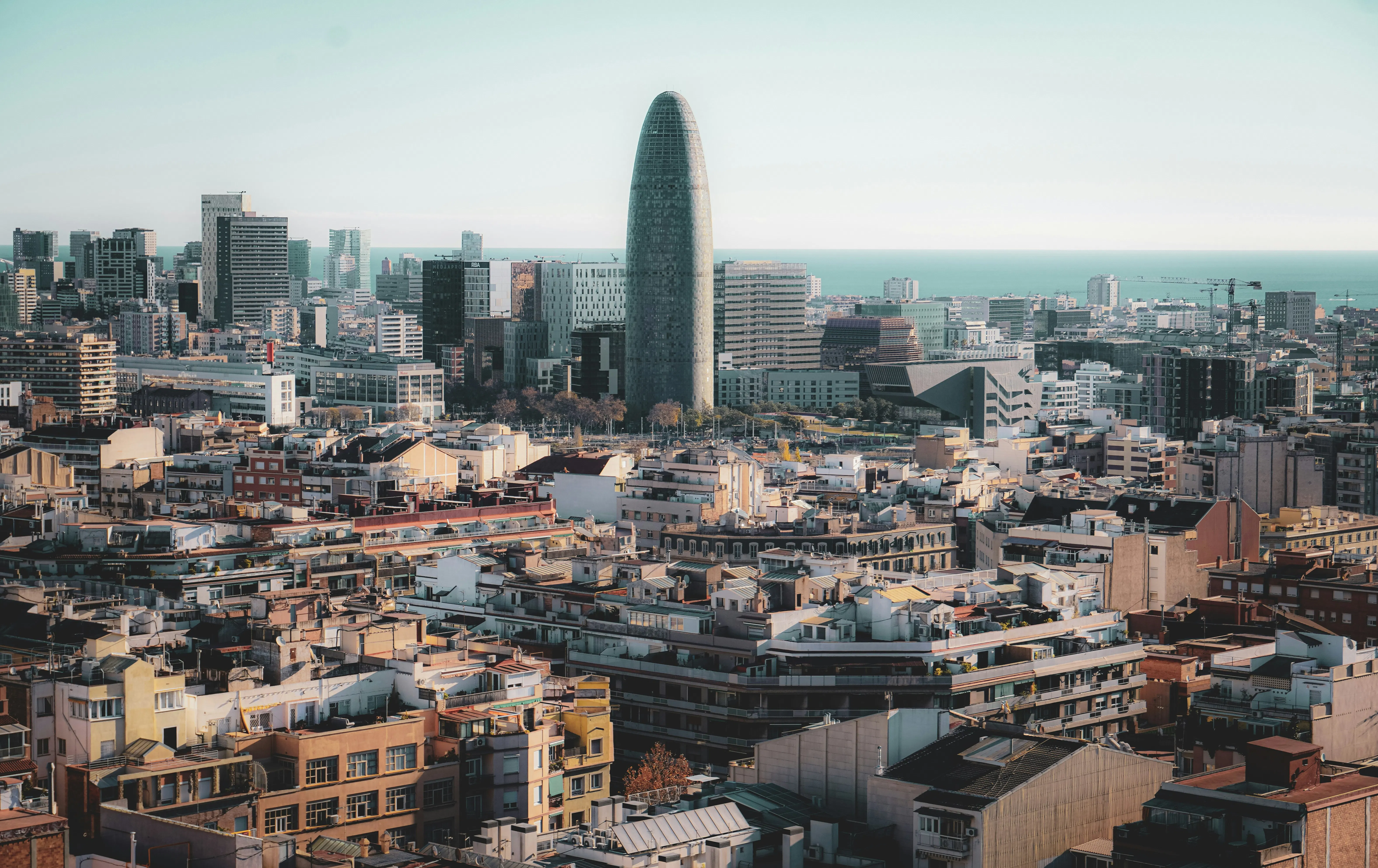 View of the iconic Torre Glòries at the heart of the 22@ tech district in Barcelona, representing the city's growth as an international innovation hub.