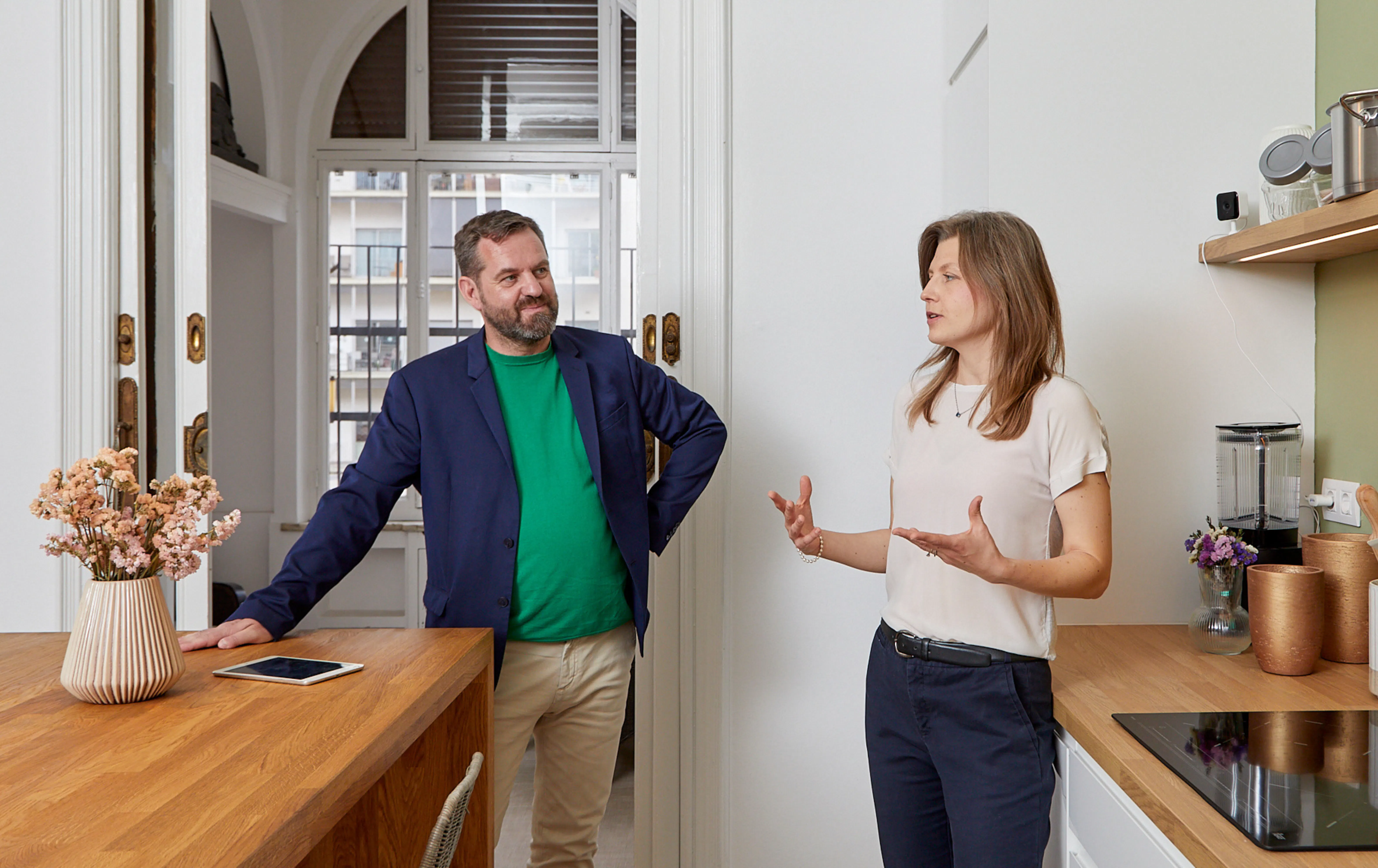 A MySpot Barcelona real estate agent showing a property to a buyer during a scheduled viewing, highlighting the space and natural light.