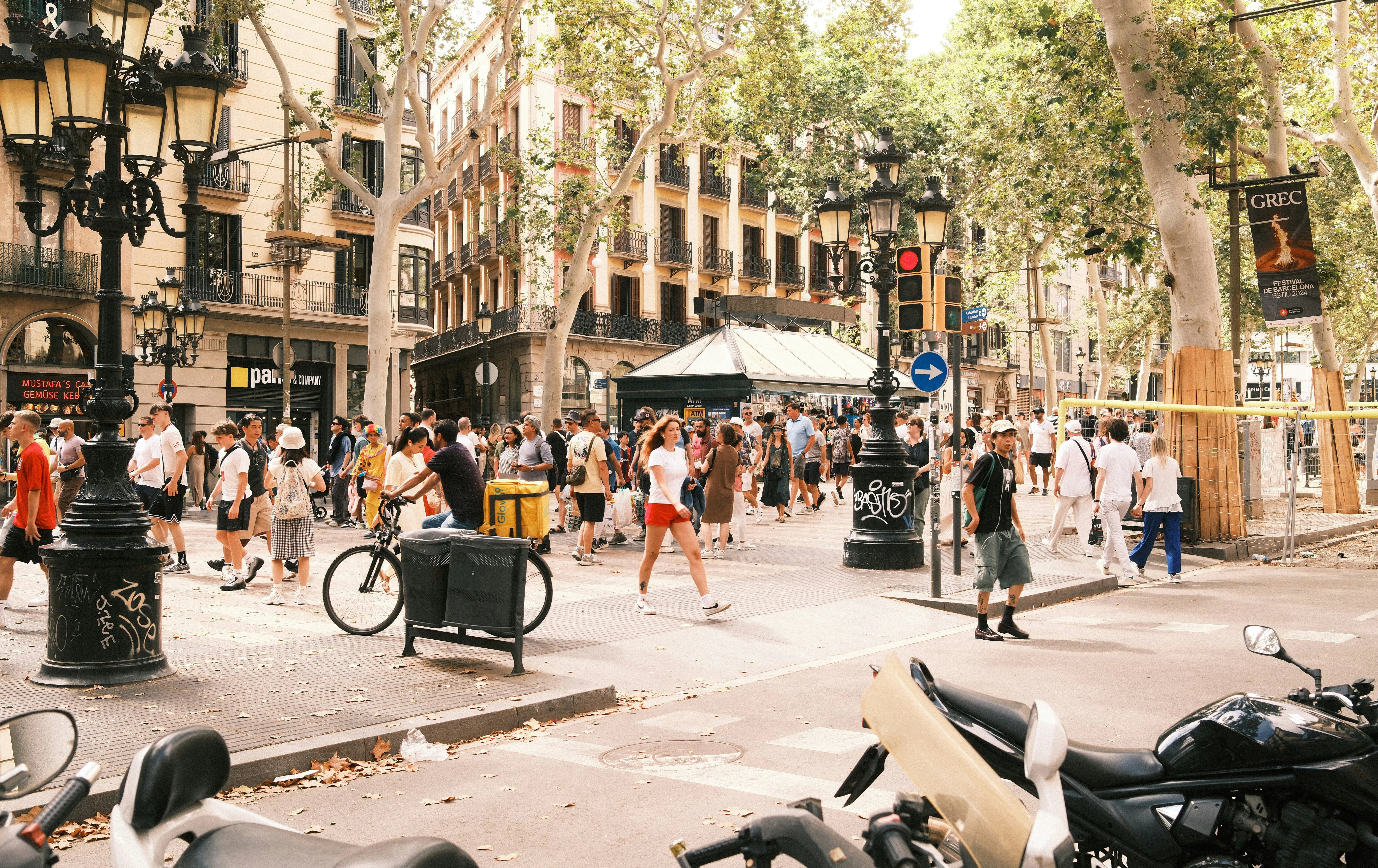 Crowded view of tourists walking along Rambla de Catalunya in Barcelona, representing the local tourism economy and short-term accommodation market.