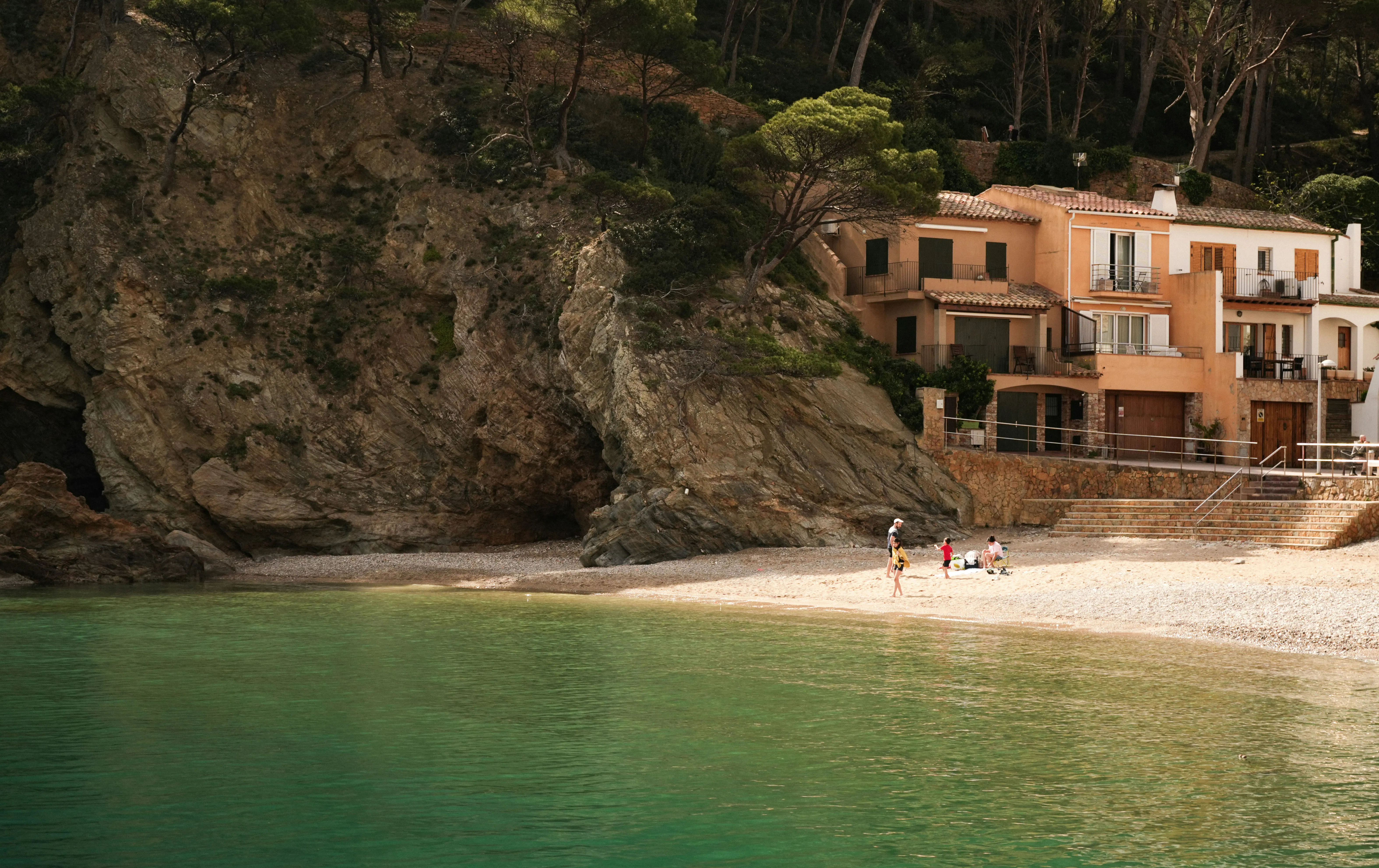 Habitatges al costat d’una cala rocosa de la Costa Brava, representatius de l’atractiu de les propietats de segona mà i les residències vinculades a l’estil de vida per als compradors internacionals a Catalunya.