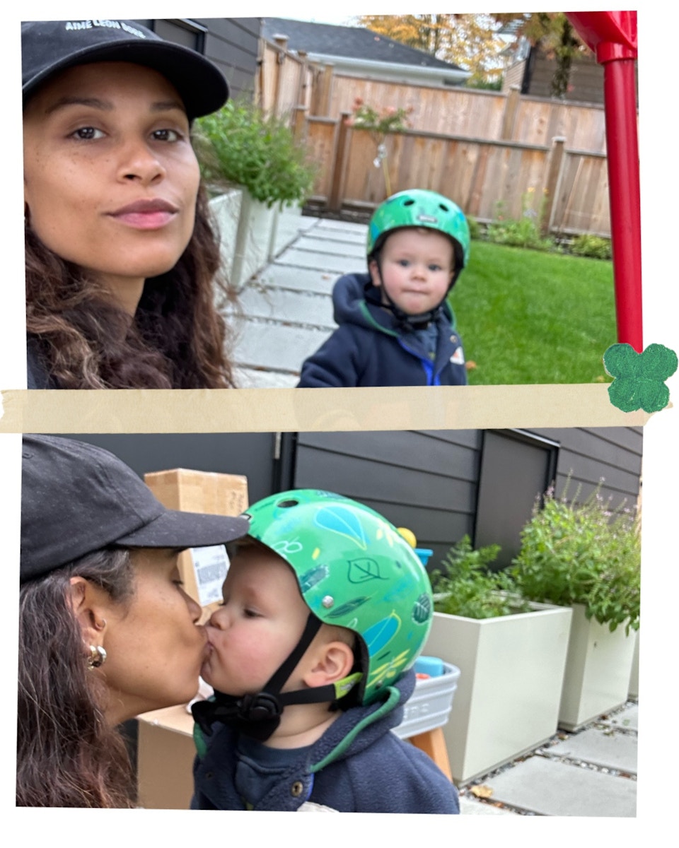 mom kissing toddler girl who wears a helmut on a scooter