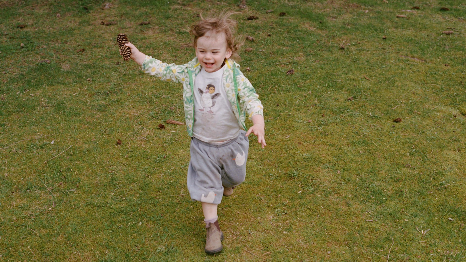 little boy running through the grass