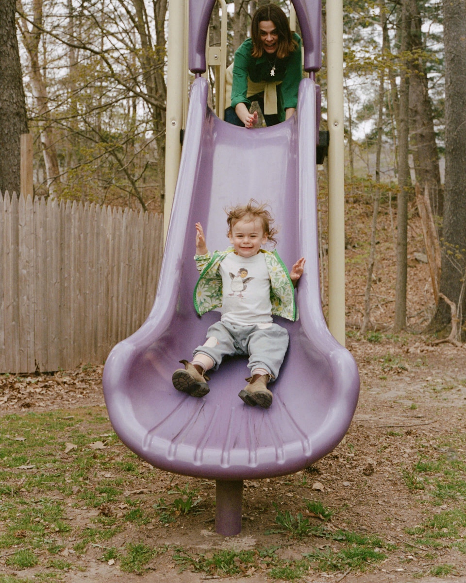 little boy coming down a slide