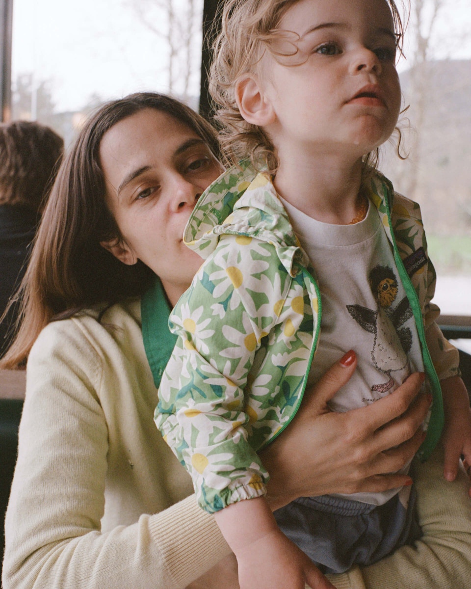 mom holding her son at a table
