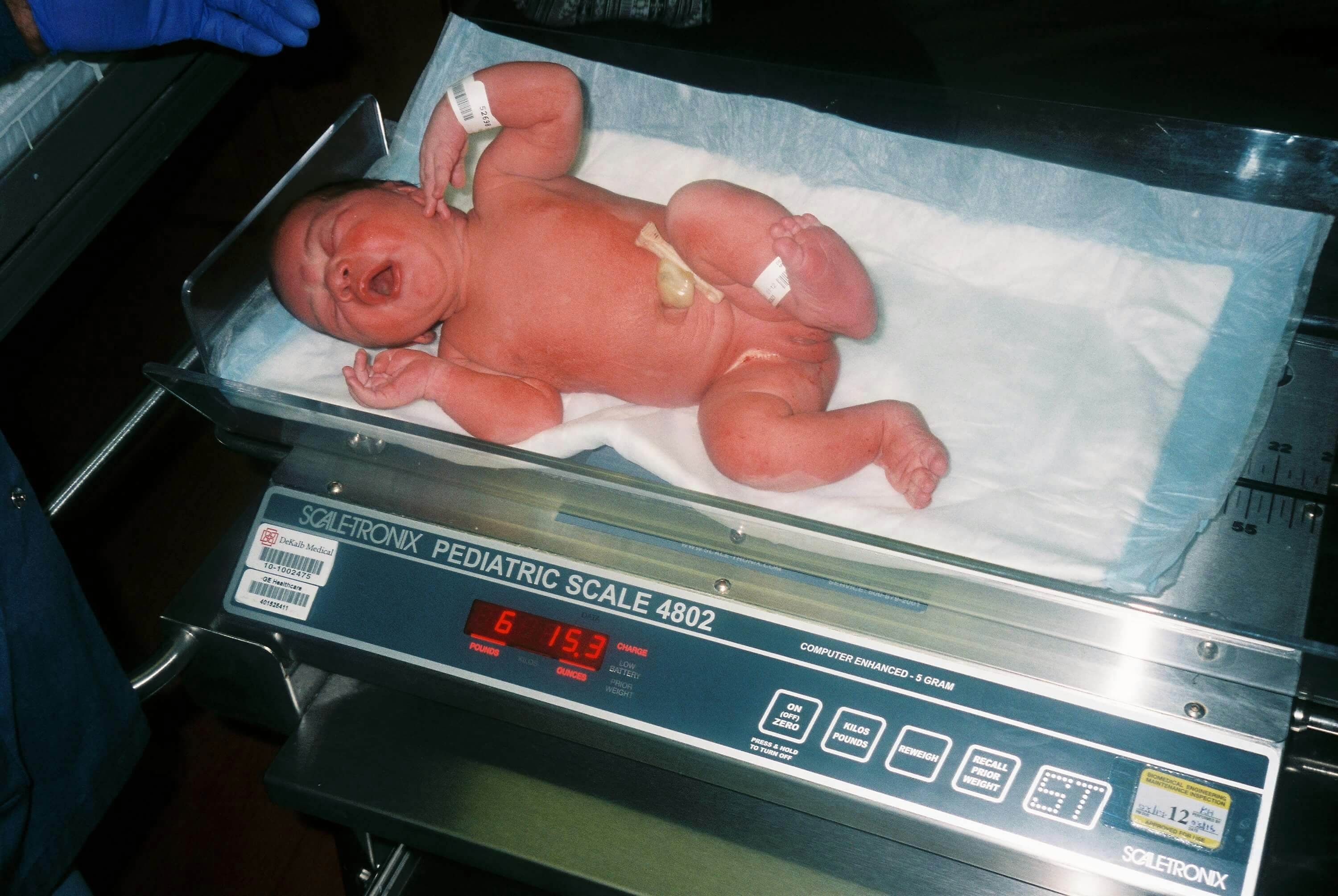 newborn being weighed