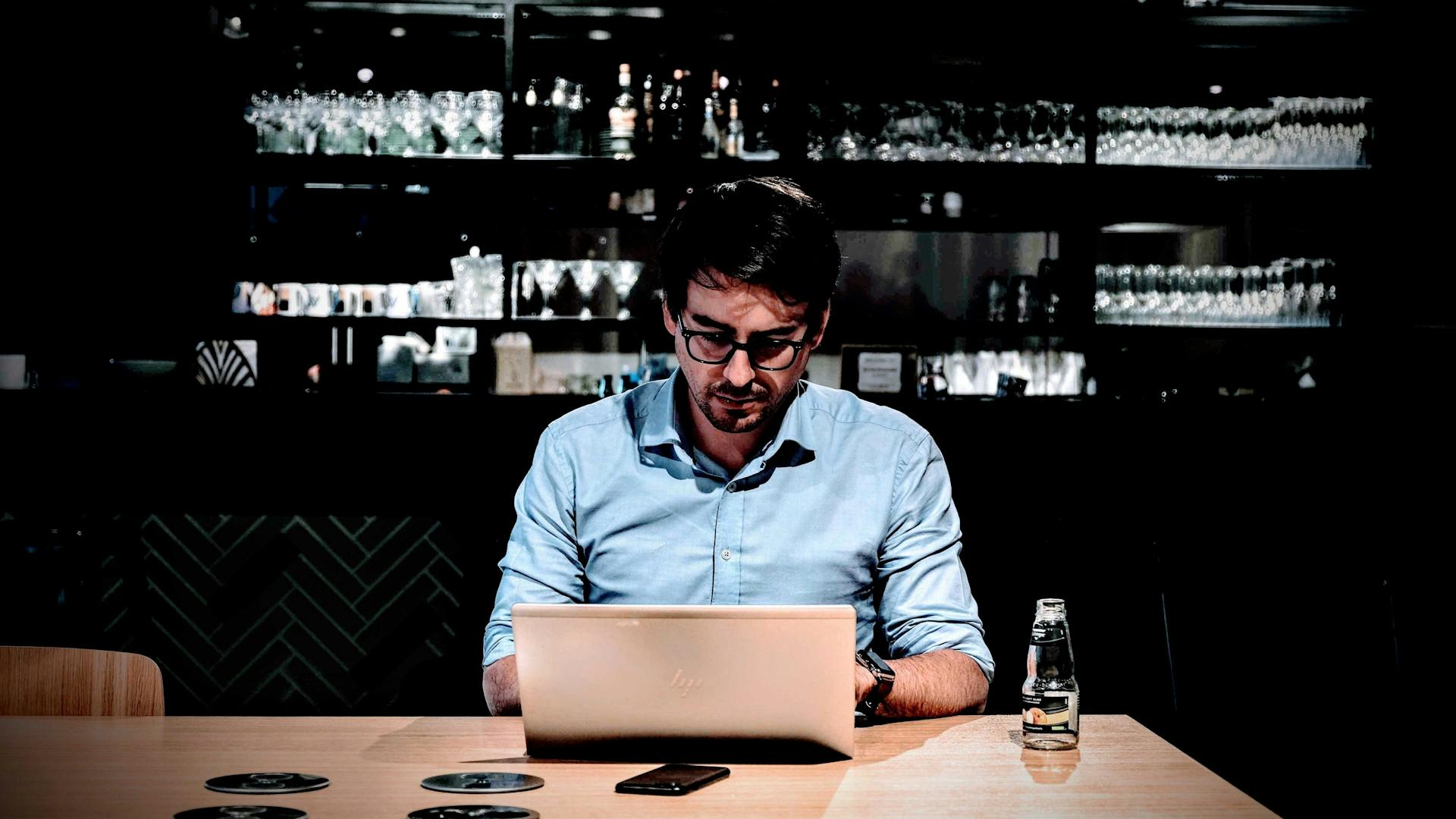 Man working on a laptop in a bar