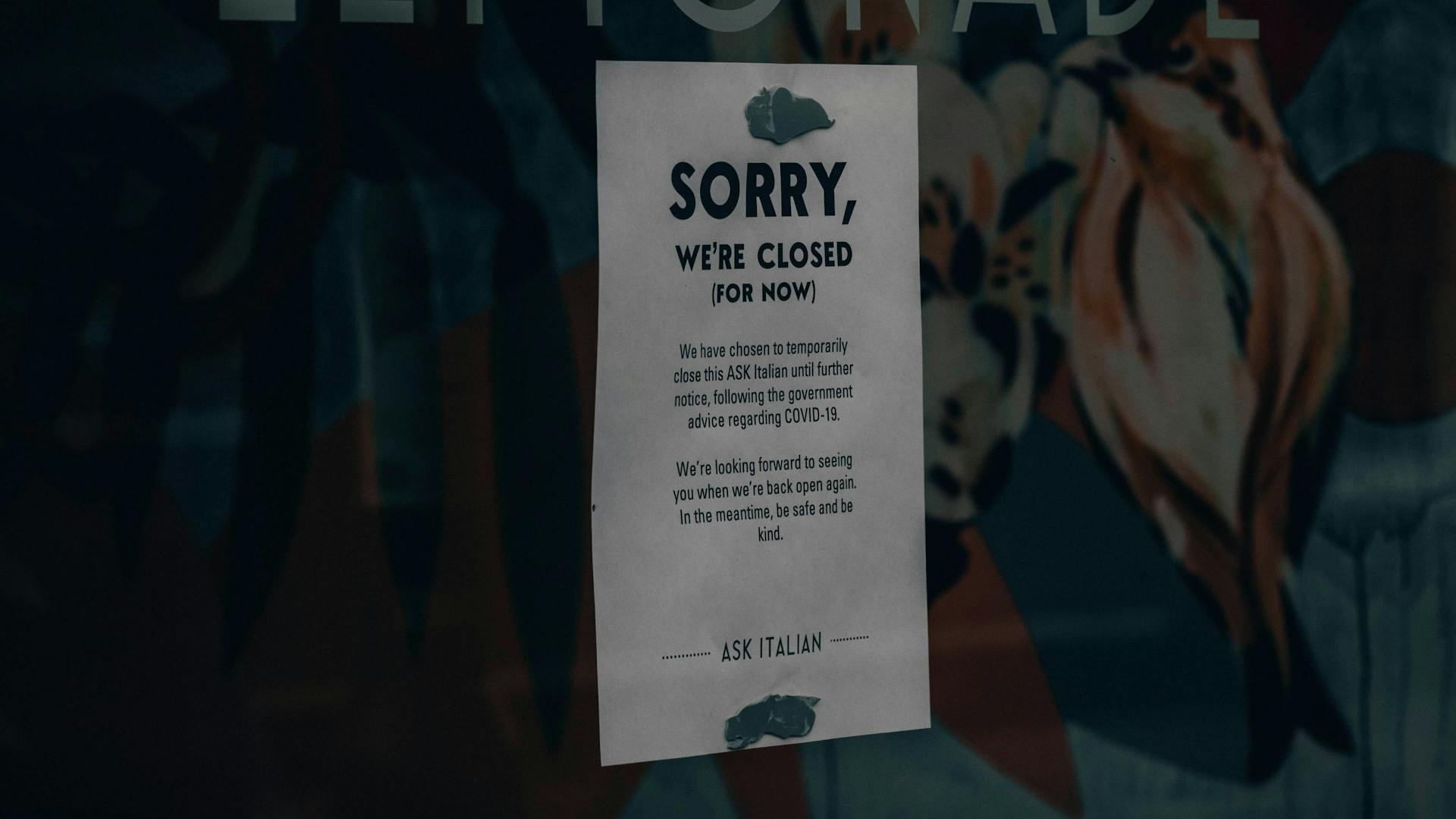 closed sign in the window of a small business