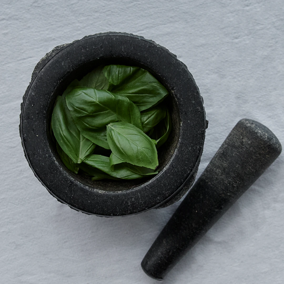 Basil leaves in mortar and pestle