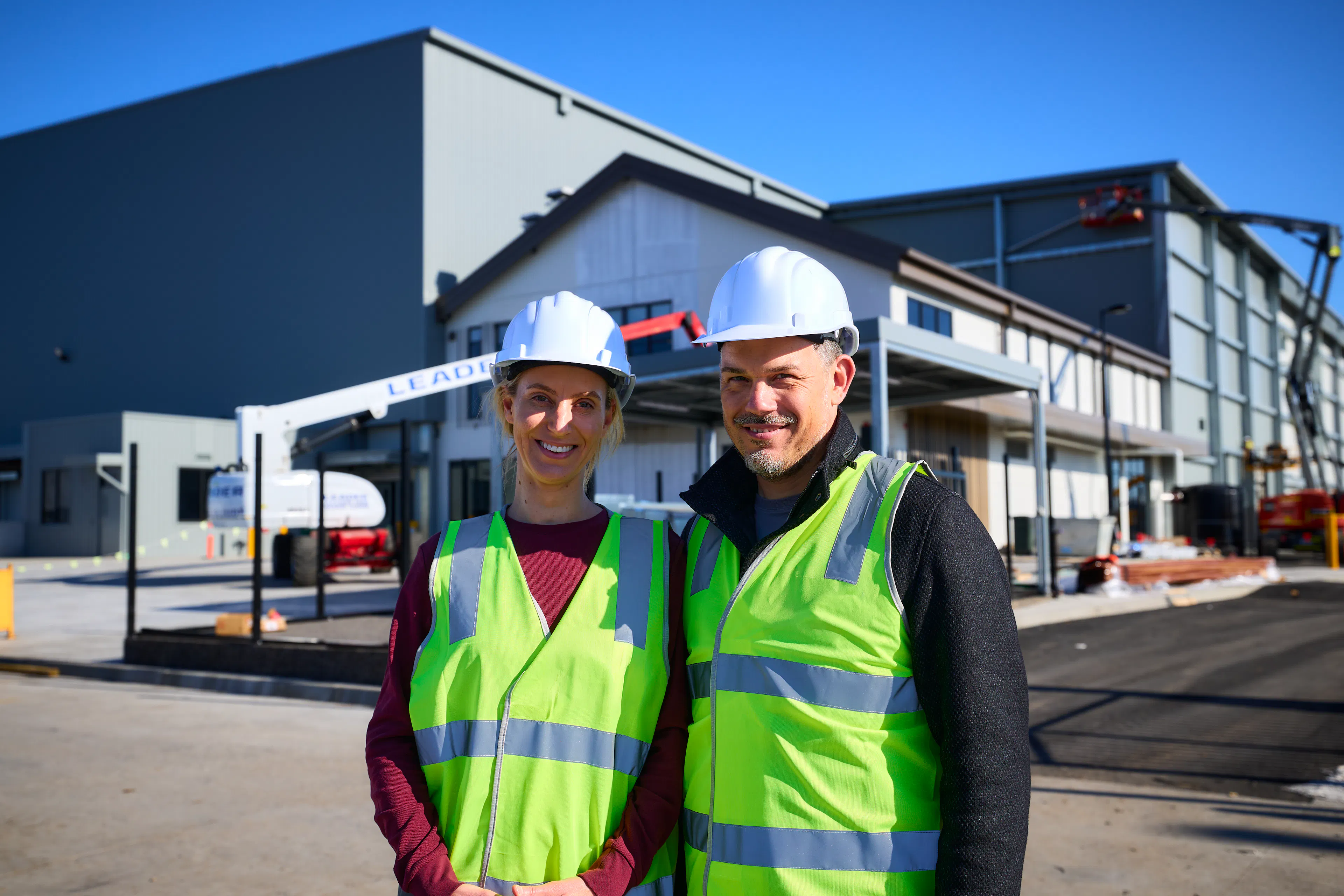 Stacked Farm co-founders Liz and Daniel Tzvetkoff standing outside the Melbourne vertical farm building.