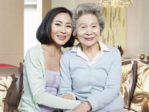 an older and younger woman sit together