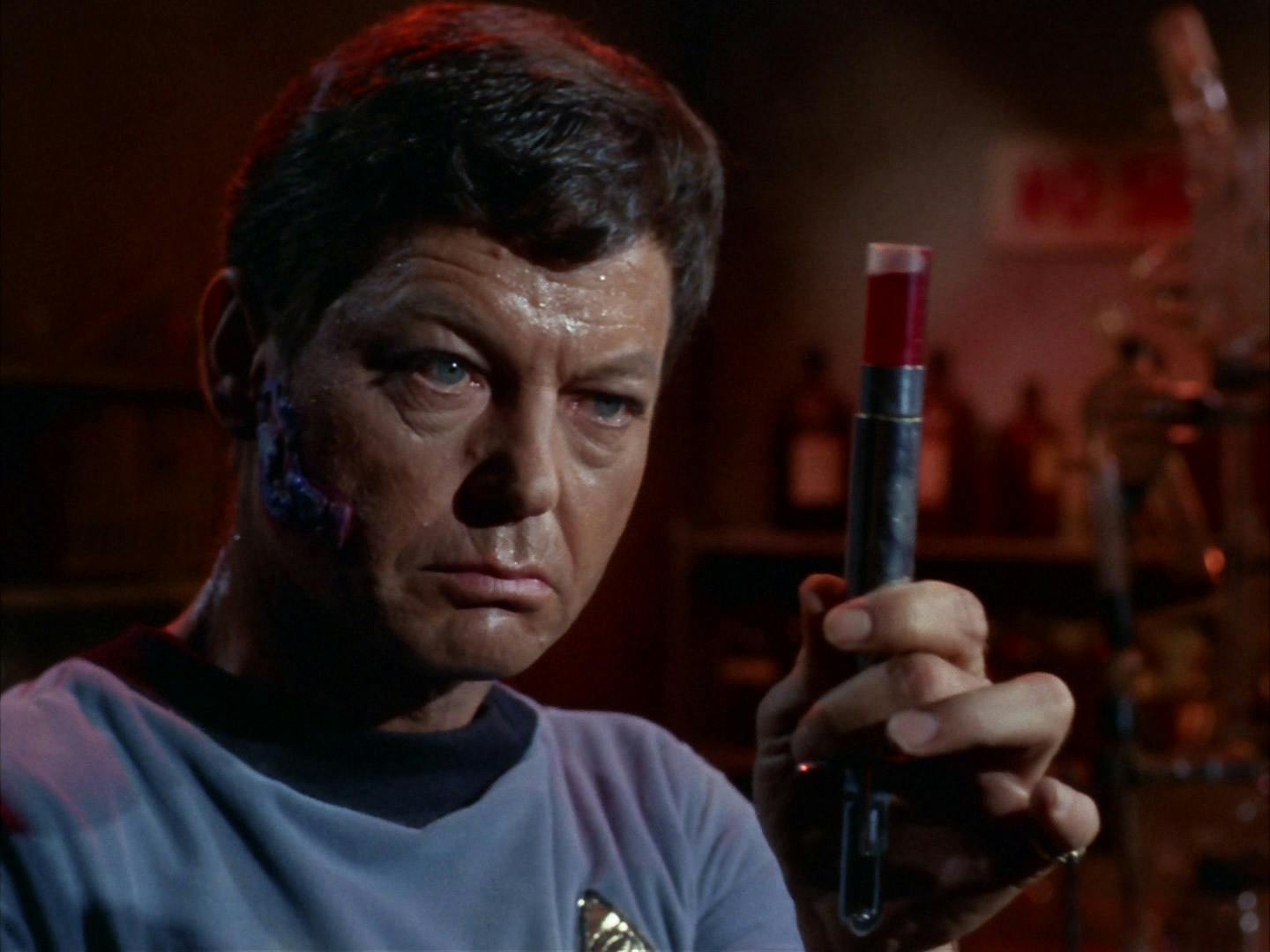 Dr. Leonard 'Bones' McCoy looks at a hypospray filled with a potentially lethal vaccine before testing it on himself before subjecting anyone else to it in 'Miri'