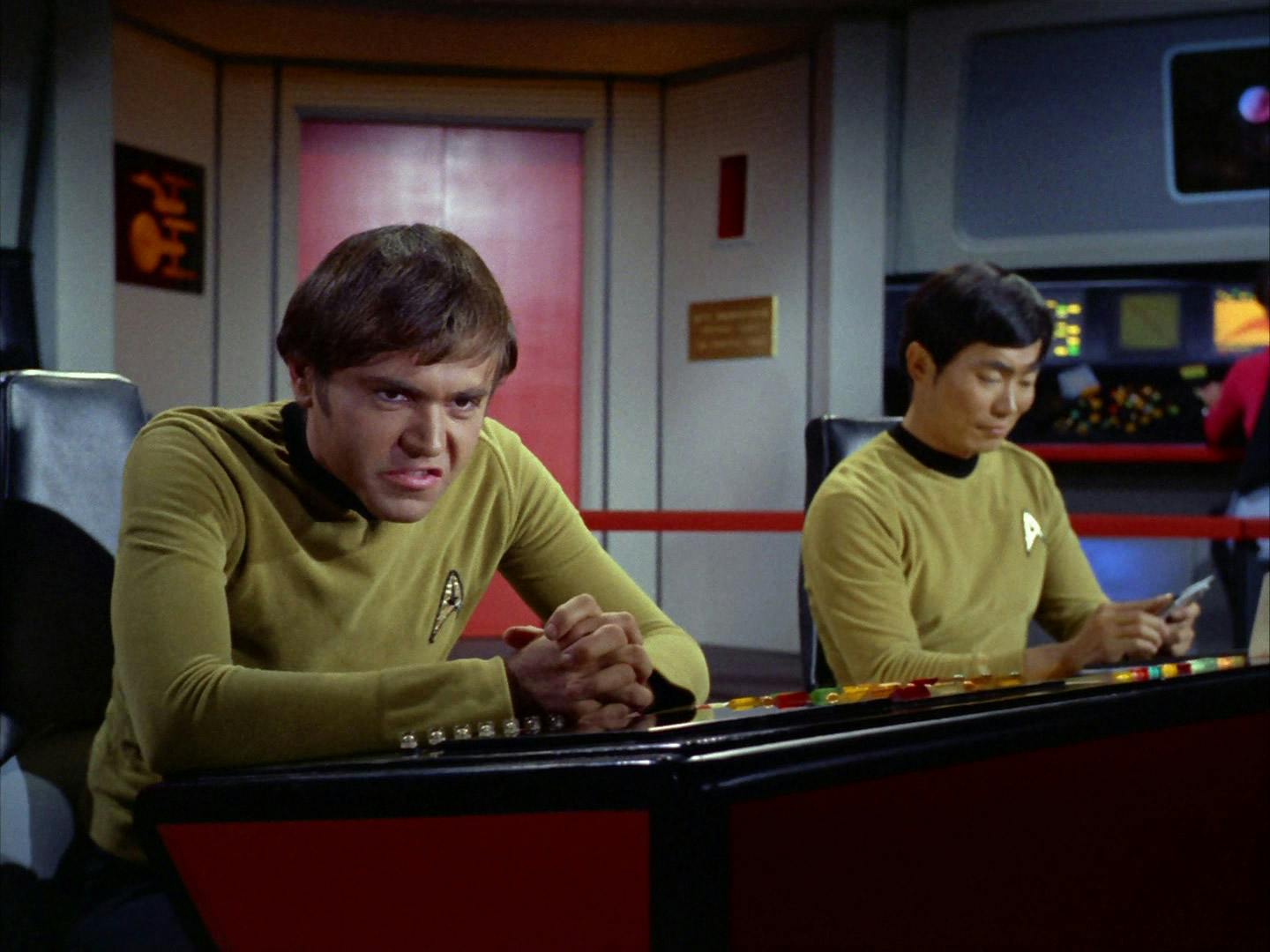 Chekov grouses at his station for being prodded so many times for McCoy's tests while Sulu finds its amusing while sitting next to him in 'The Deadly Years'