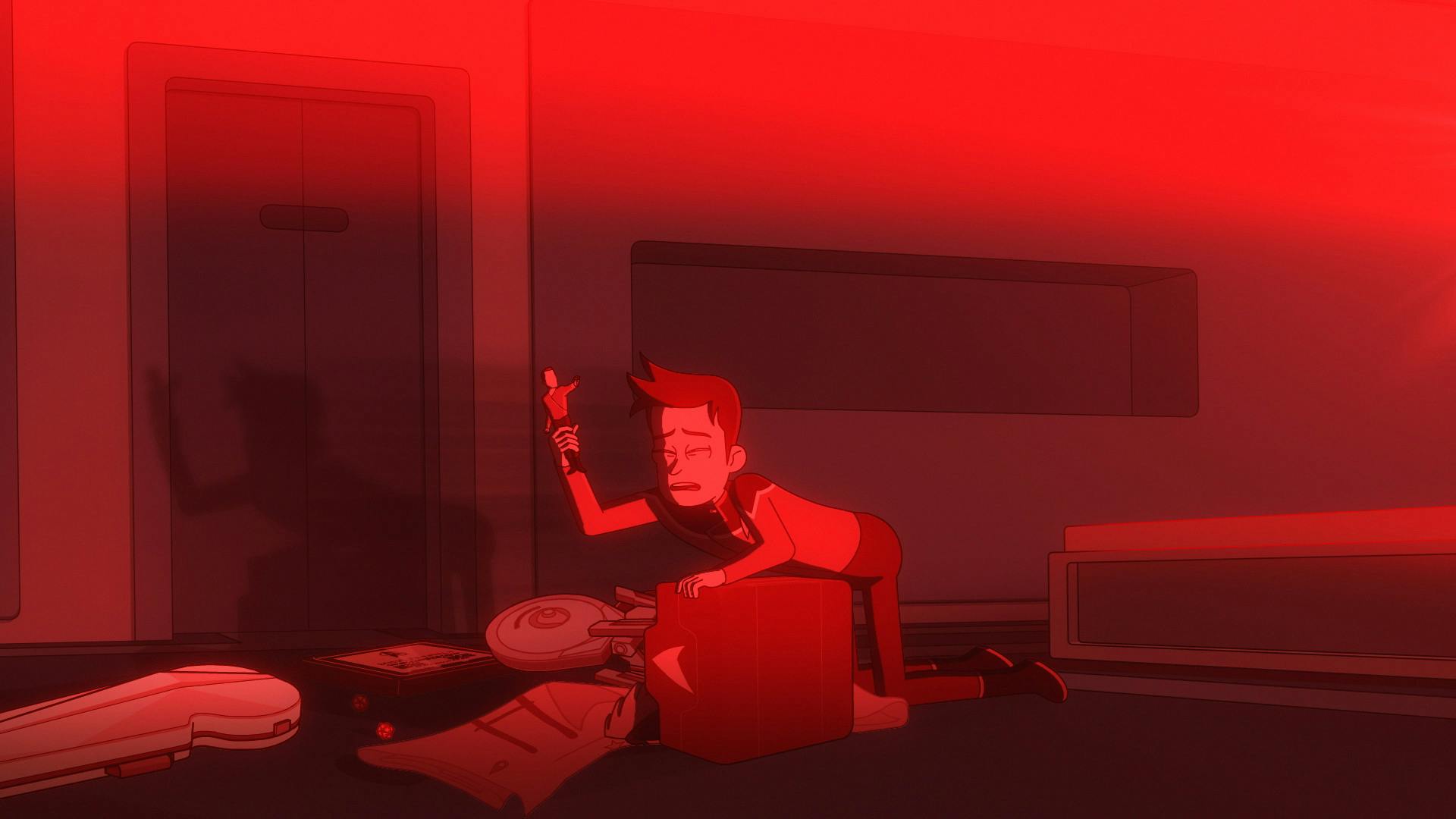 In his new quarters, Boimler is blinded by the lights from the nacelles, closes his eyes and trips over his box of belongings that have fallwen over while gripping his Mirror Universe Archer action figure in his hand in 'I Have No Bones Yet I Must Flee'