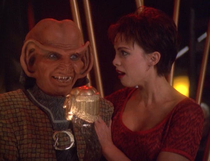 In Quark's Bar, Rom and Leeta are in shock as the Ferengi is chosen as the next Grand Nagus and handed the ceremonial staff in 'The Dogs of War'