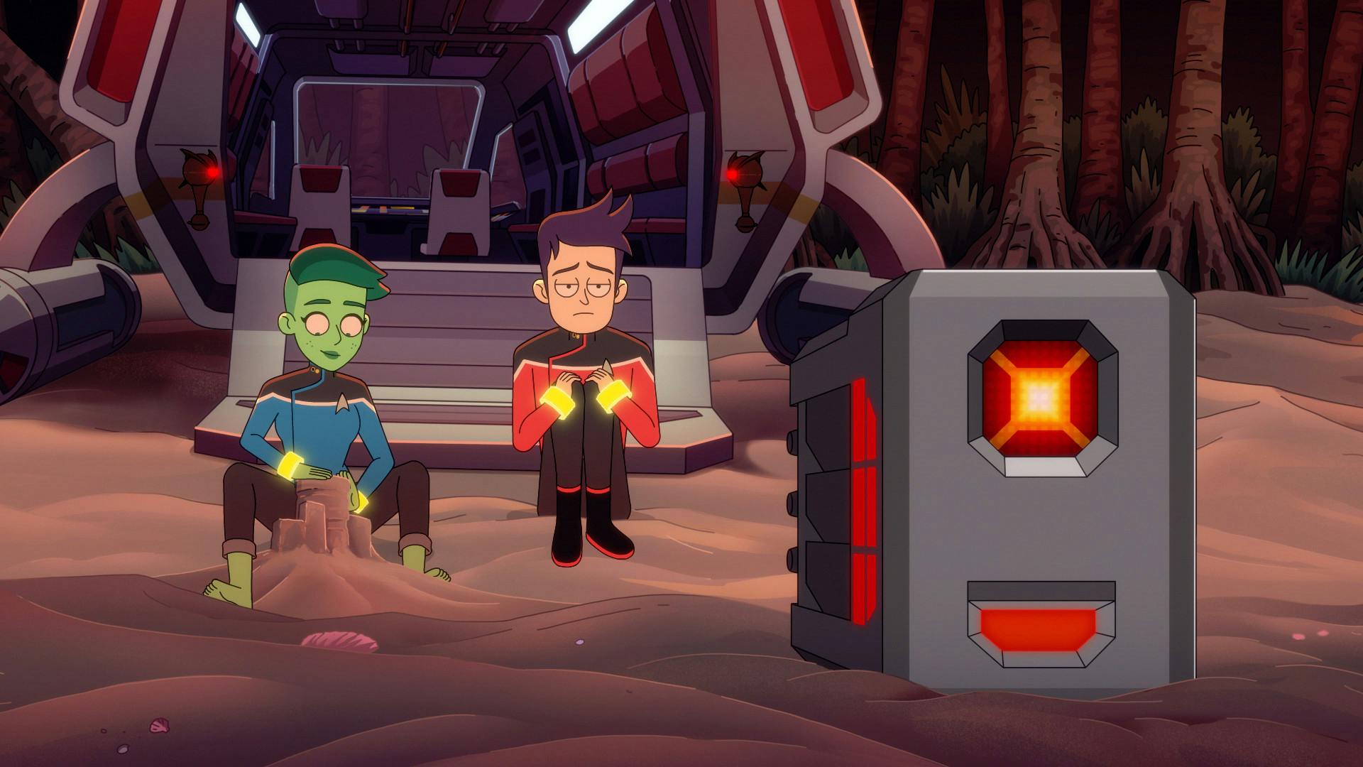Outside of their shuttle on the shores of a beachy planet, a tied up Tendi builds a sand castle while Boimler glumly looks in front of him towards Agimus in 'A Few Badgeys More'