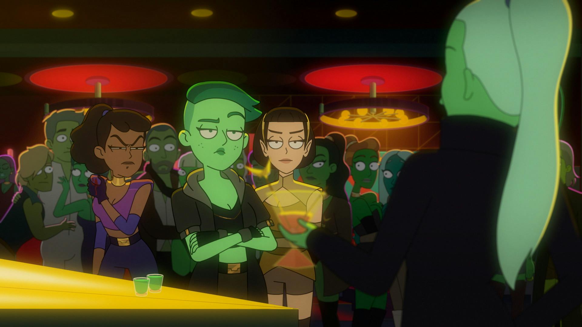 At the Slit Throat Orion Nightclub, Orions stop to watch Madame G, while holding a drink, approaches Tendi, T'Lyn, and Mariner who is applying pressure to her shoulder wound in 'Something Borrowed, Something Green' 
