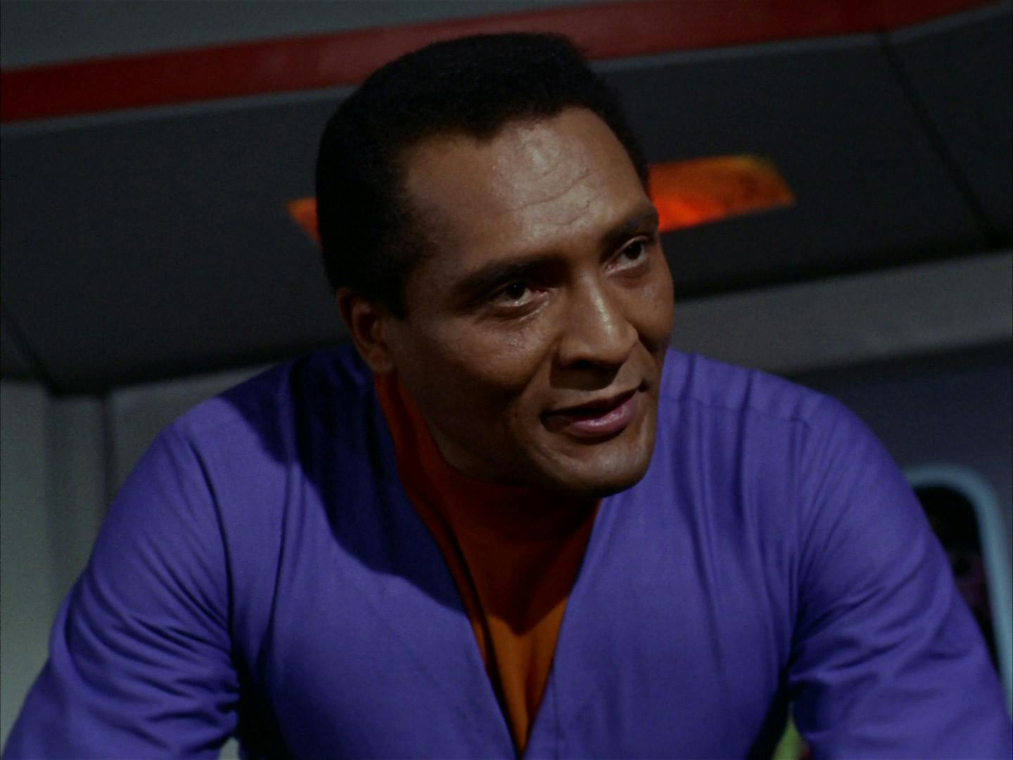 Close-up of Dr. Richard Daystrom (William Marshall) as he leans over a console in Star Trek: The Original Series' 'The Ultimate Computer'
