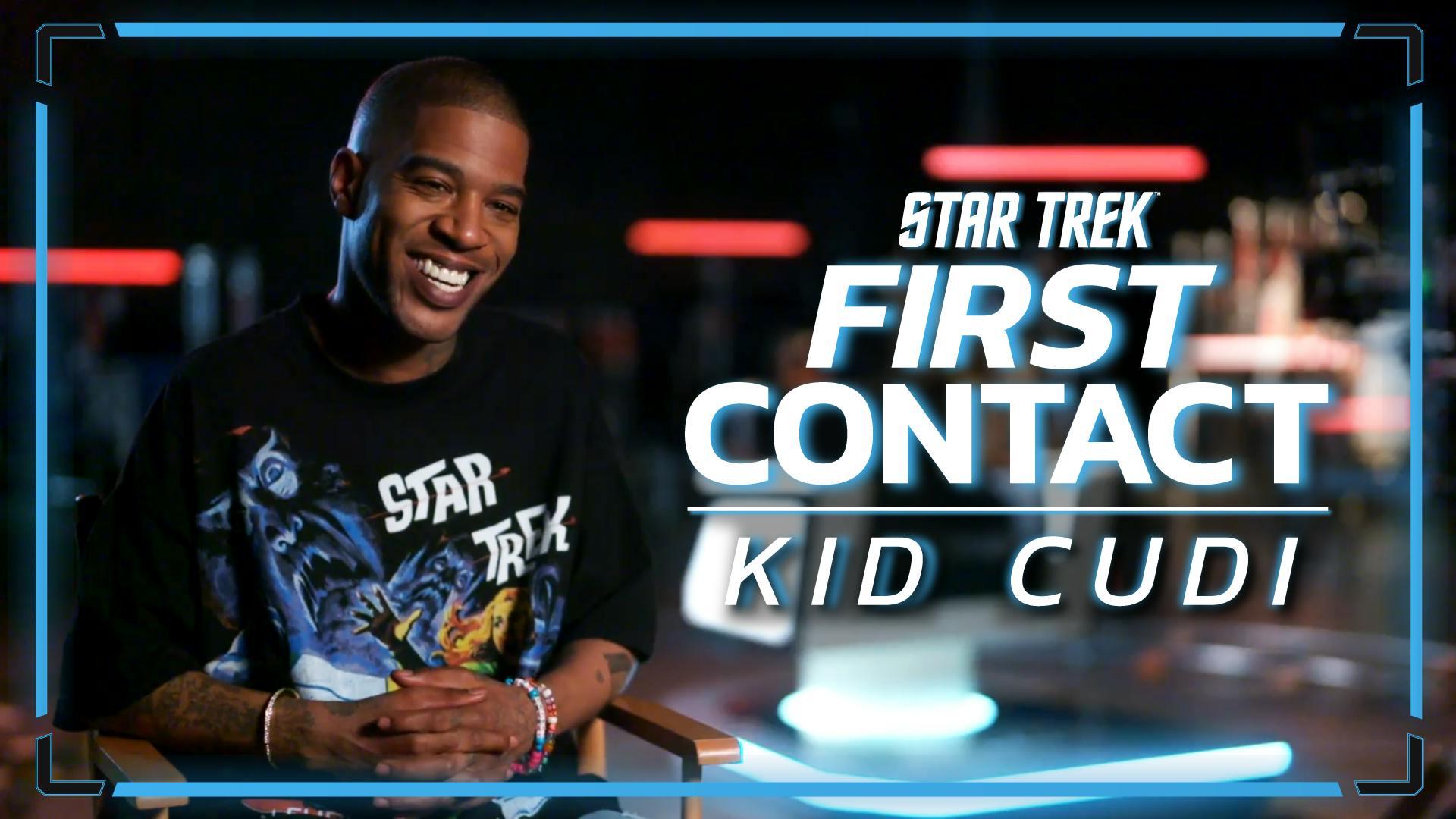 Kid Cudi sits in a director's chair while on set for his promotional capture for the Star Trek Fortnite experience with the text 'Star Trek: First Contact | Kid Cudi'