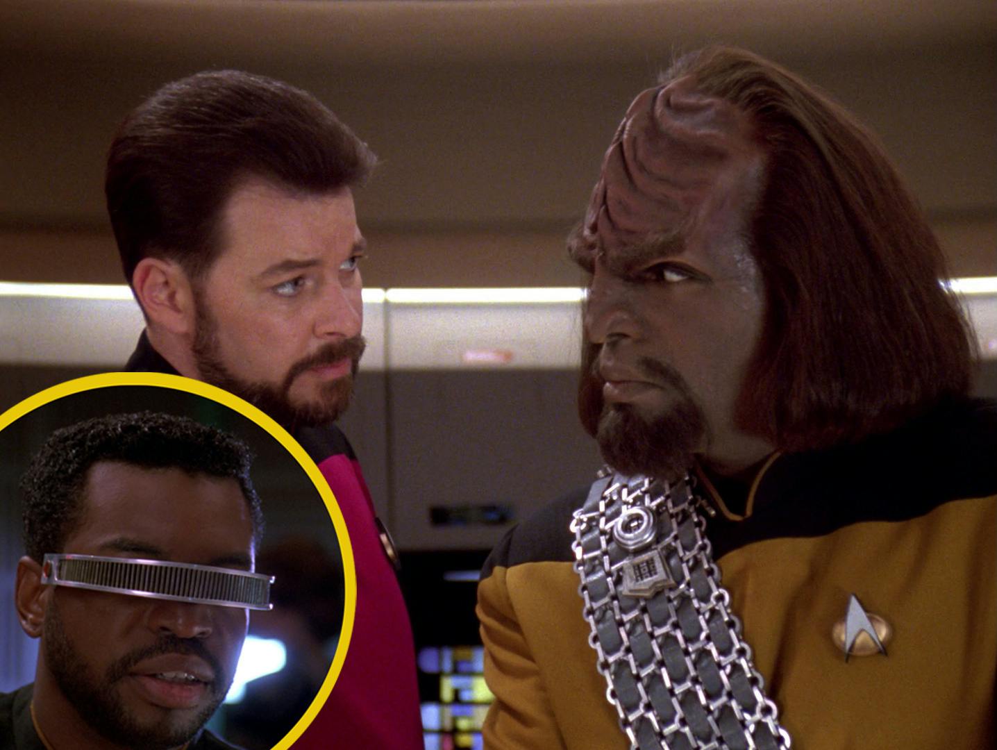 Close-up of Riker and Worf as they face each other on the bridge of the Enterprise with a layered image of a bearded Geordi La Forge enclosed in a circle from 'The Quality of Life'