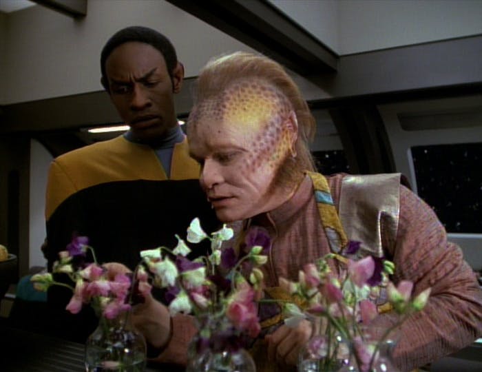 Neelix tends to his flowers as Tuvok peers over his shoulder in 'Learning Curve'