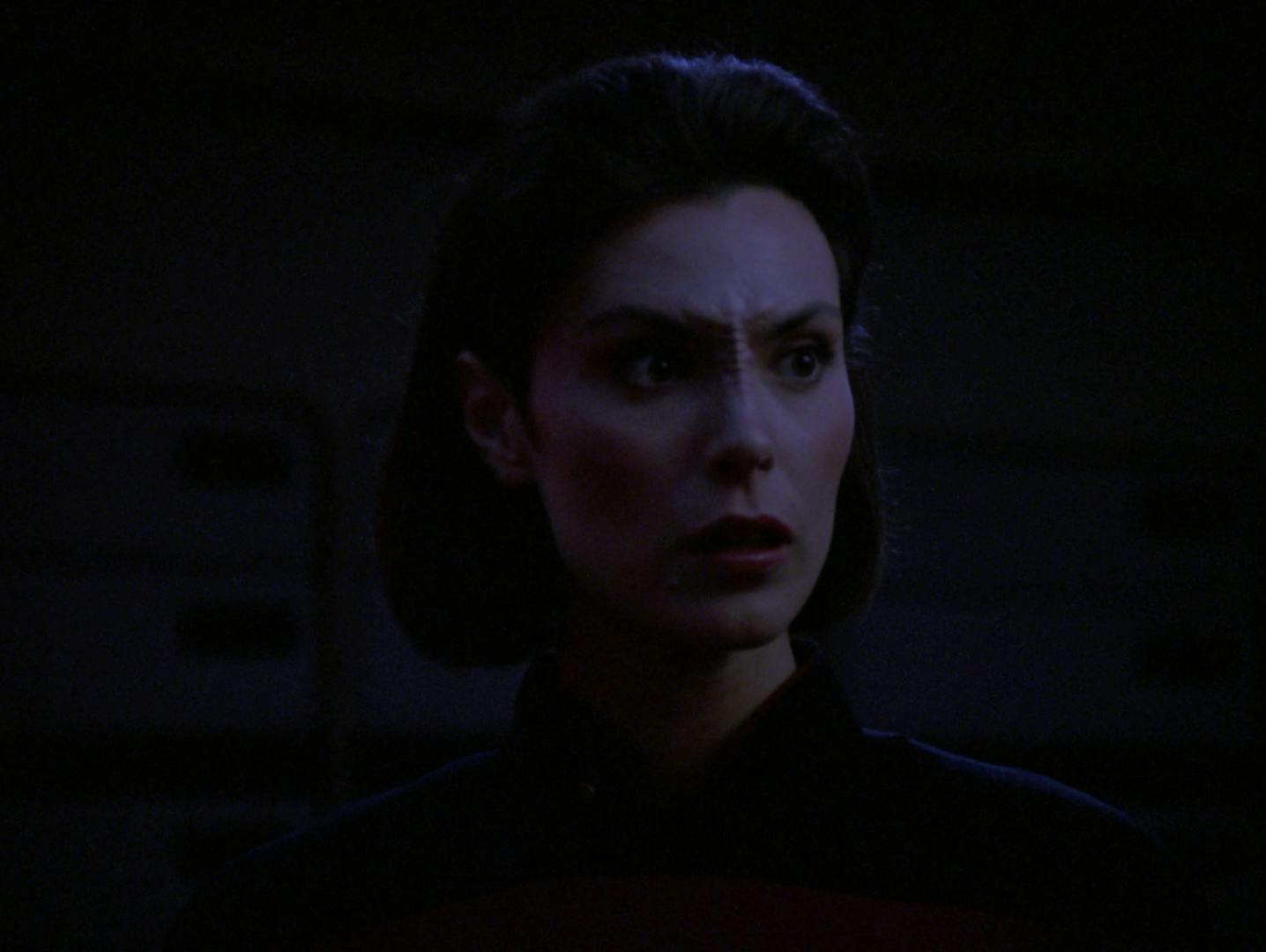 Close-up of Ro Laren as the bridge of the Enterprise loses power in 'Disaster'