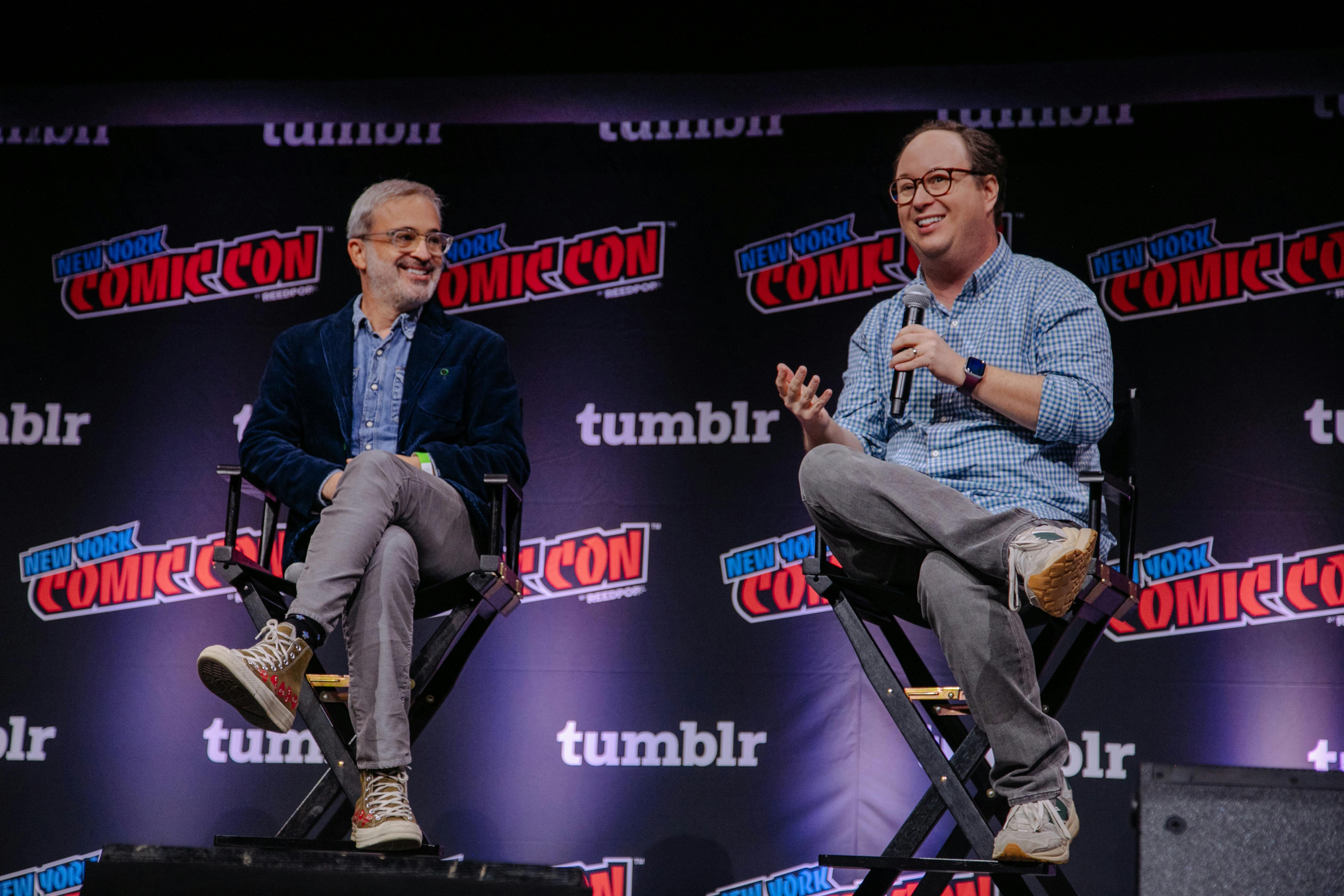 Alex Kurtzman looks over at Mike Mahan who is speaking on the NYCC 2023 stage during the Star Trek universe panel 