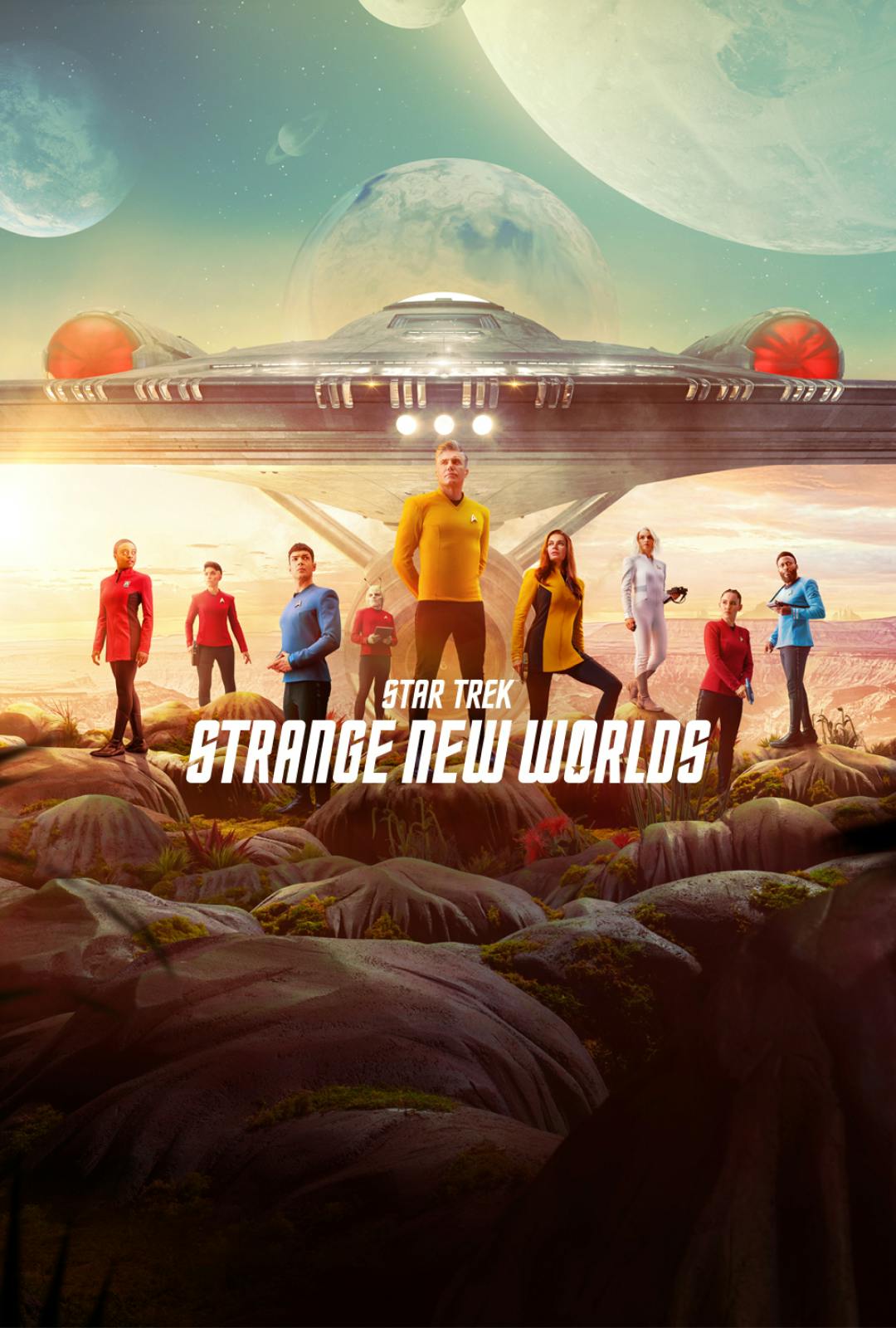 Key Art for Star Trek: Strange New Worlds Season 1 showing Captain Pike and the crew on the surface of a Strange New World with the U.S.S. Enterprise behind them and several moons and planets in the sky. 