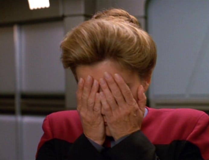 Captain Janeway brings her palms to cover her face in 'Persistence of Vision'