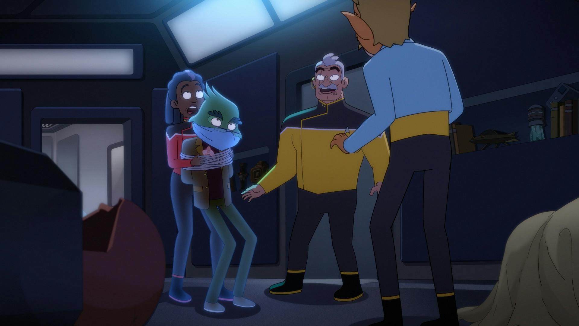 Captain Freeman and Shaxs express horror as they grab a tied up and gagged Dr. Migleemo as T'Illups faces them in 'Twovix'
