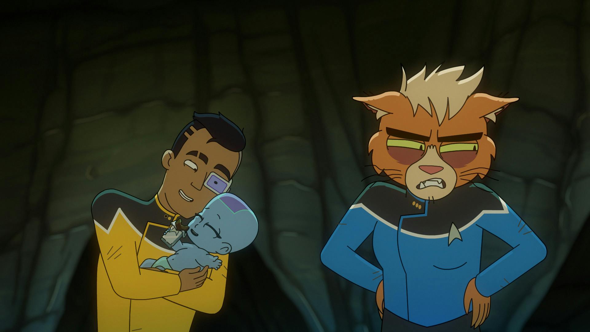 Rutherford lovingly cradles his baby who is enjoying a food bar as Dr. T'Ana is exhausted and surly next to them in 'Caves'