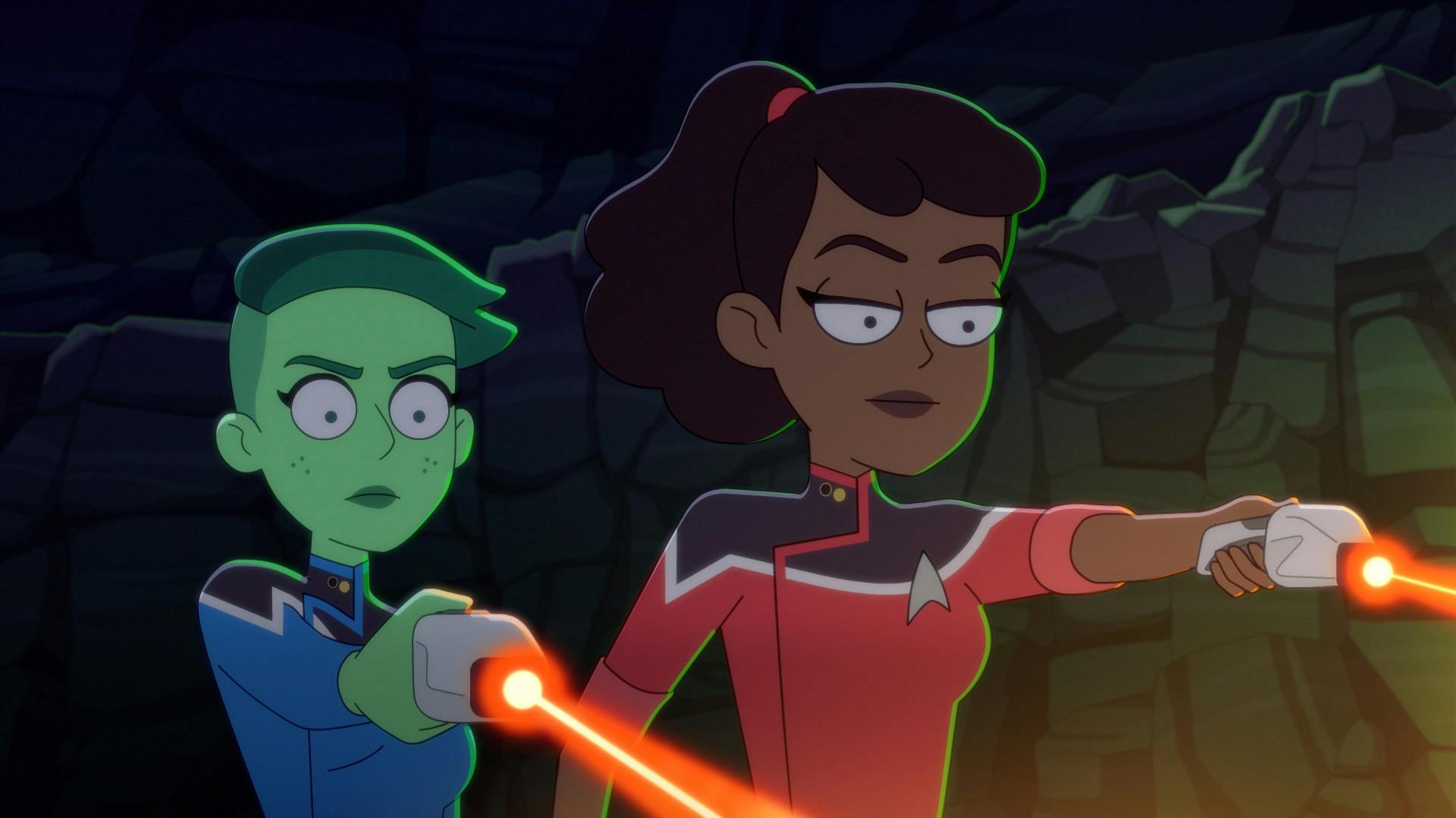 Tendi and Mariner aim their phasers at the glowing moss while trapped in 'Caves'